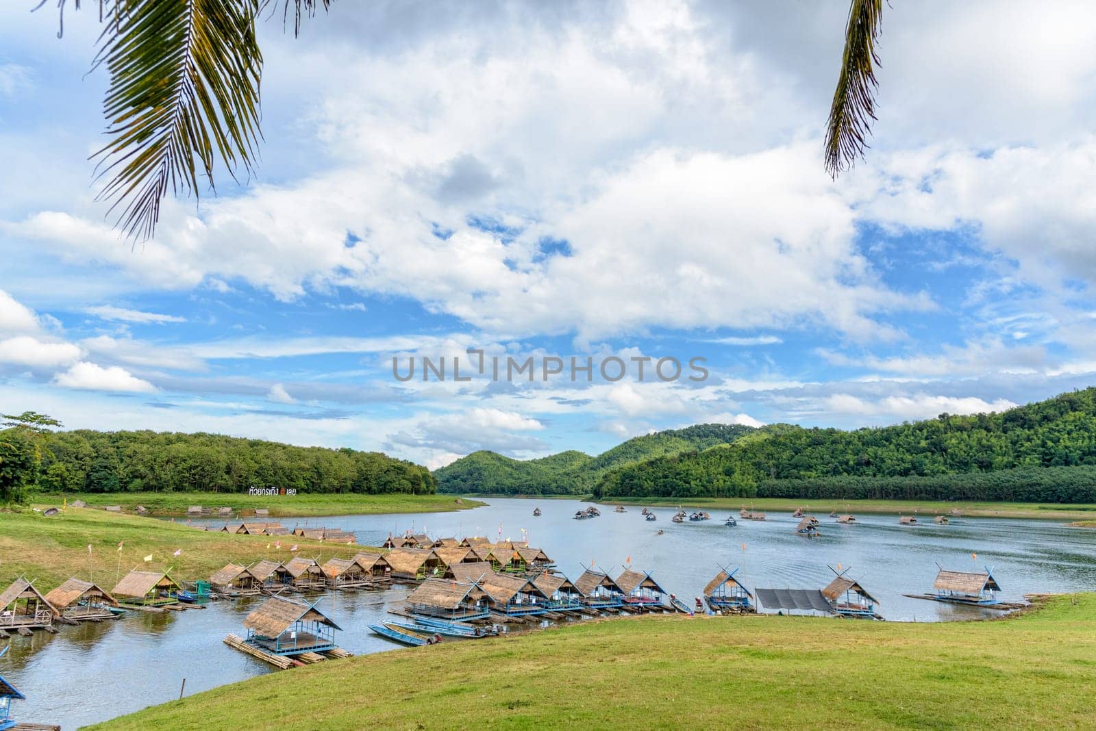 Beautiful natural landscape of the river, mountain, blue sky, green forest and bamboo raft shelter is part of the floating restaurant at Huai Krathing is a tourist attraction of Loei province, Thailand