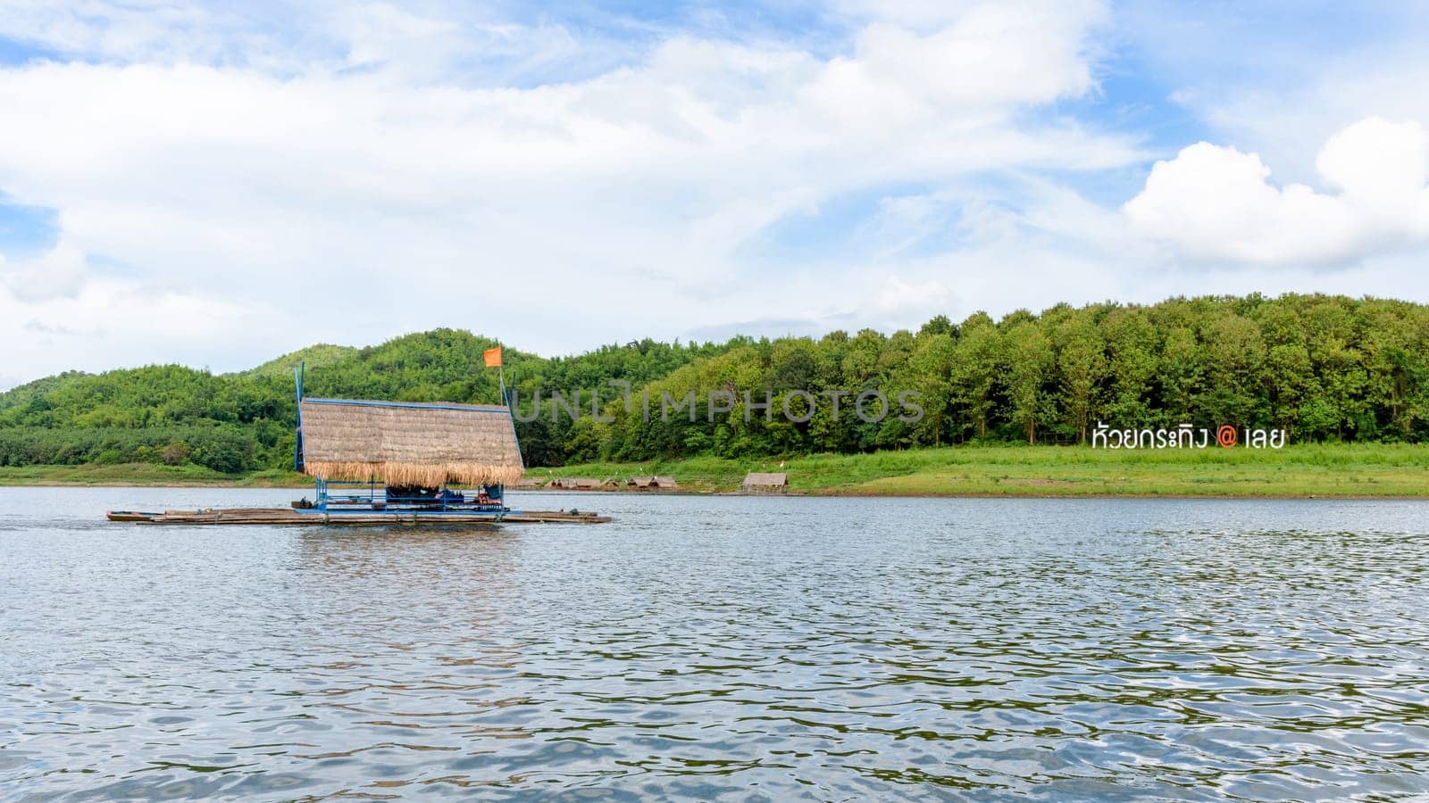 Place nameplate of Huai Krathing and bamboo raft shelter are floating restaurant in the middle of water under the blue sky as a tourist attraction of Loei province,Thailand, 16:9 widescreen