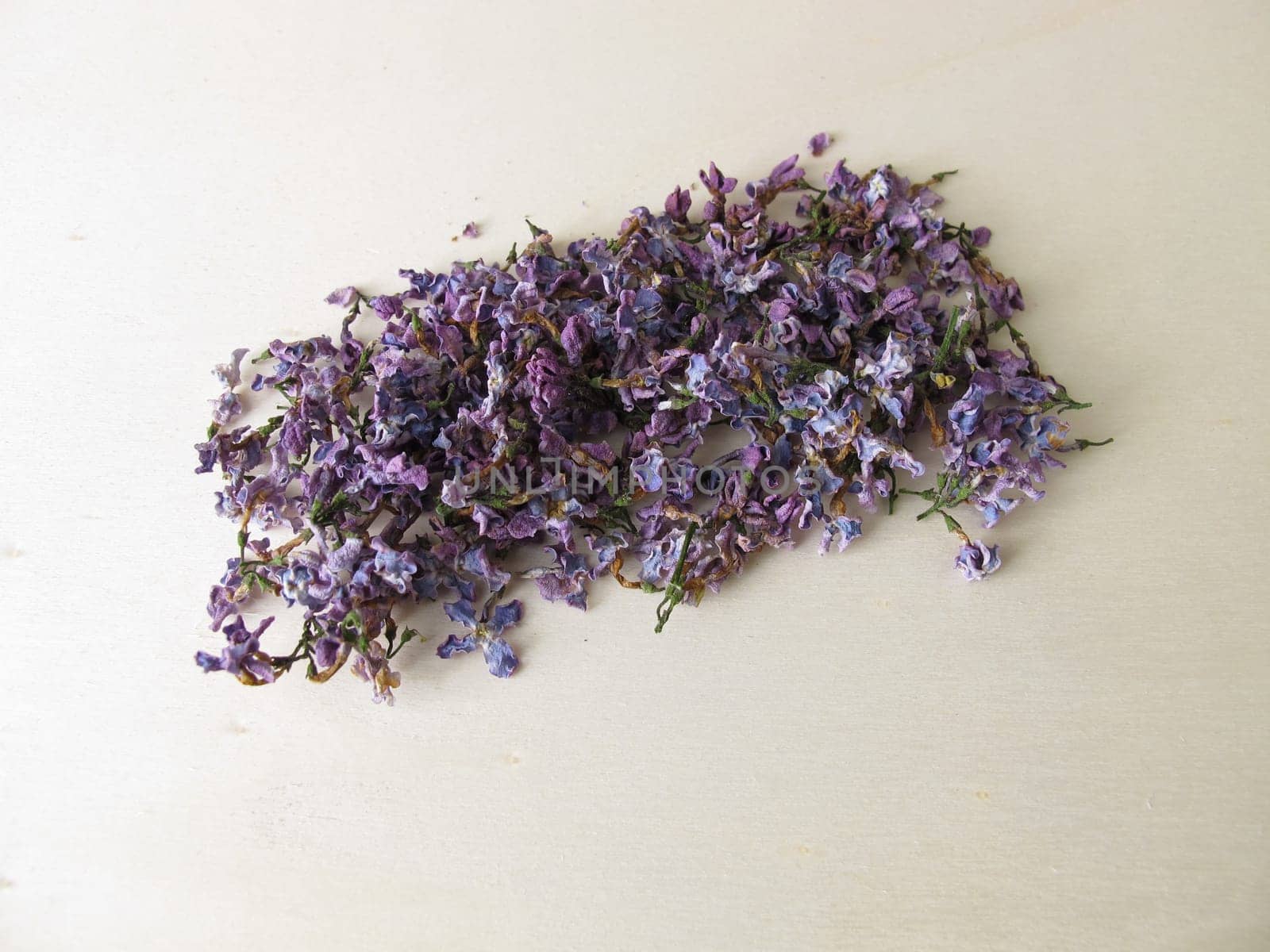 Dried lilac flowers on wooden board