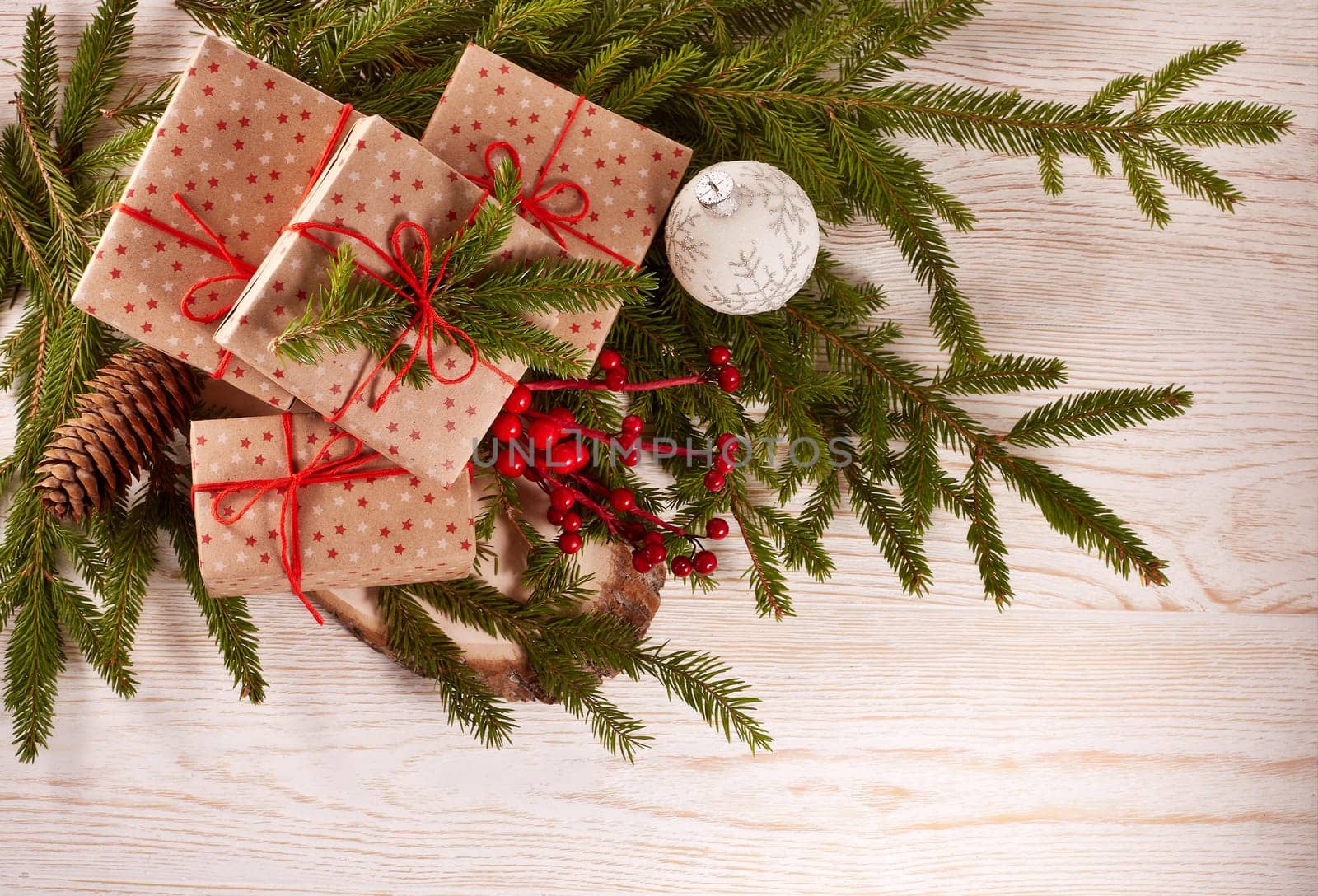 Still life with gift boxes, fir tree branches and christmas decorations on a wooden background.Top view with copy space. Christmas and New Year