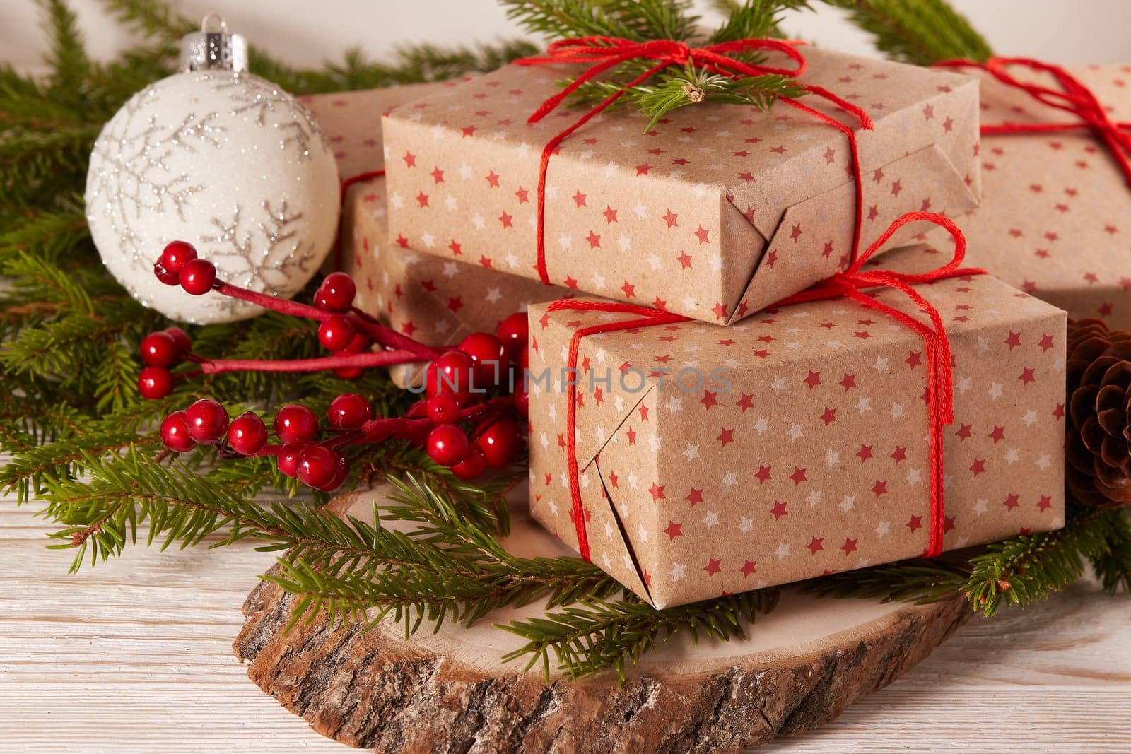Still life with gift boxes, fir tree branches and christmas decorations on a wooden table. Christmas and New Year