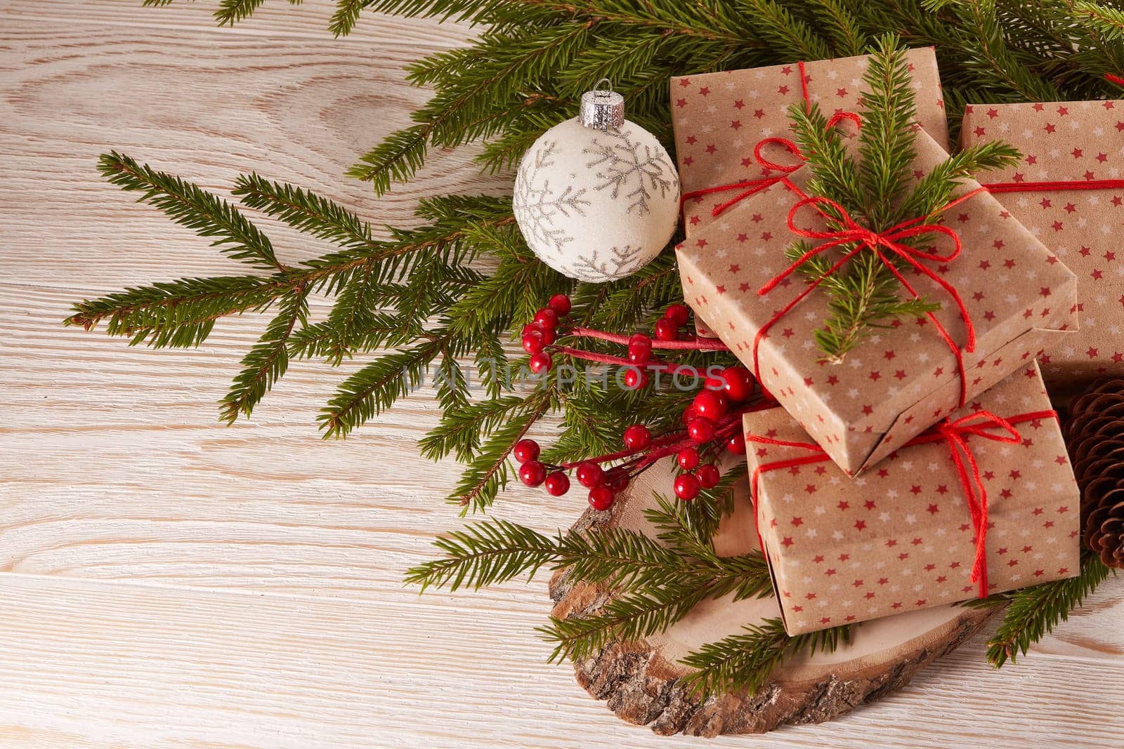 Still life with gift boxes, fir tree branches and christmas decorations on a wooden background.Top view. Christmas and New Year