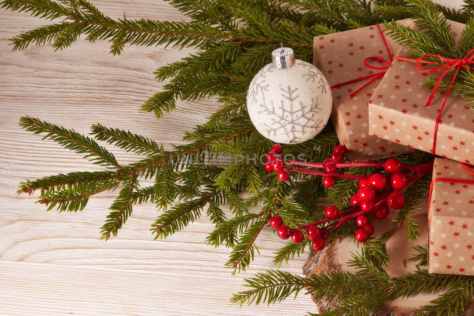 Still life with gift boxes, fir tree branches and christmas decorations on a wooden background.Top view. Christmas and New Year