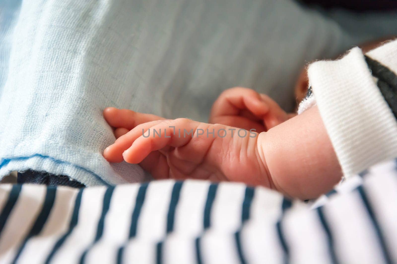 hand of a newborn child while sleeping peacefully