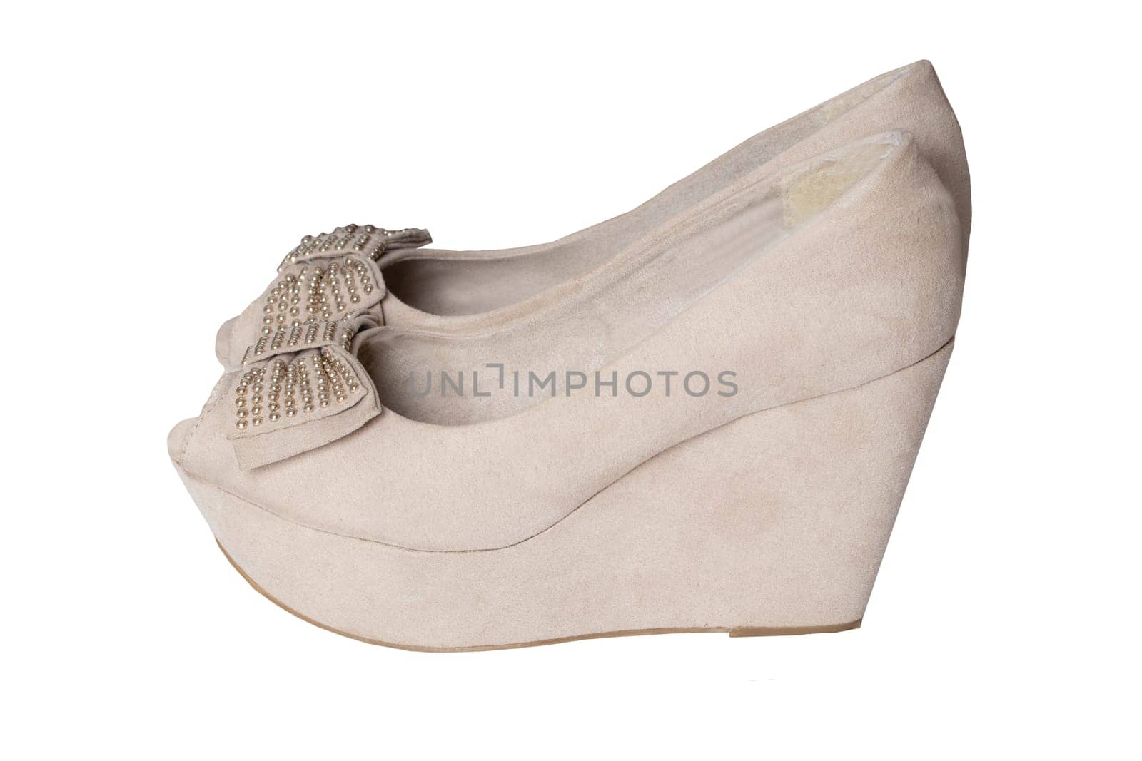 Shoe fashion. A pair of beige denim womens suede high heels shoes isolated on a white background.