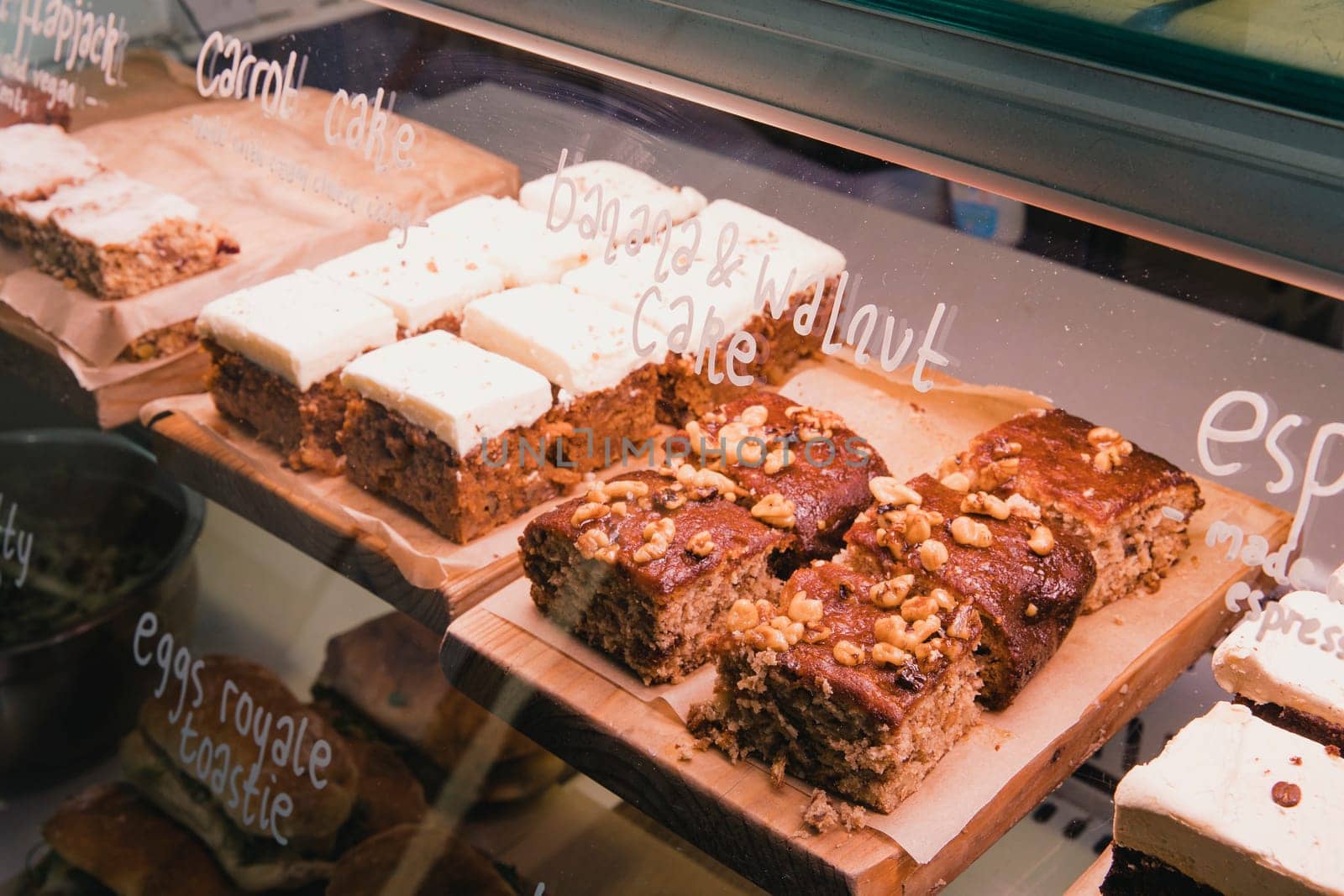 Selection of cakes in a coffee shops display unit.