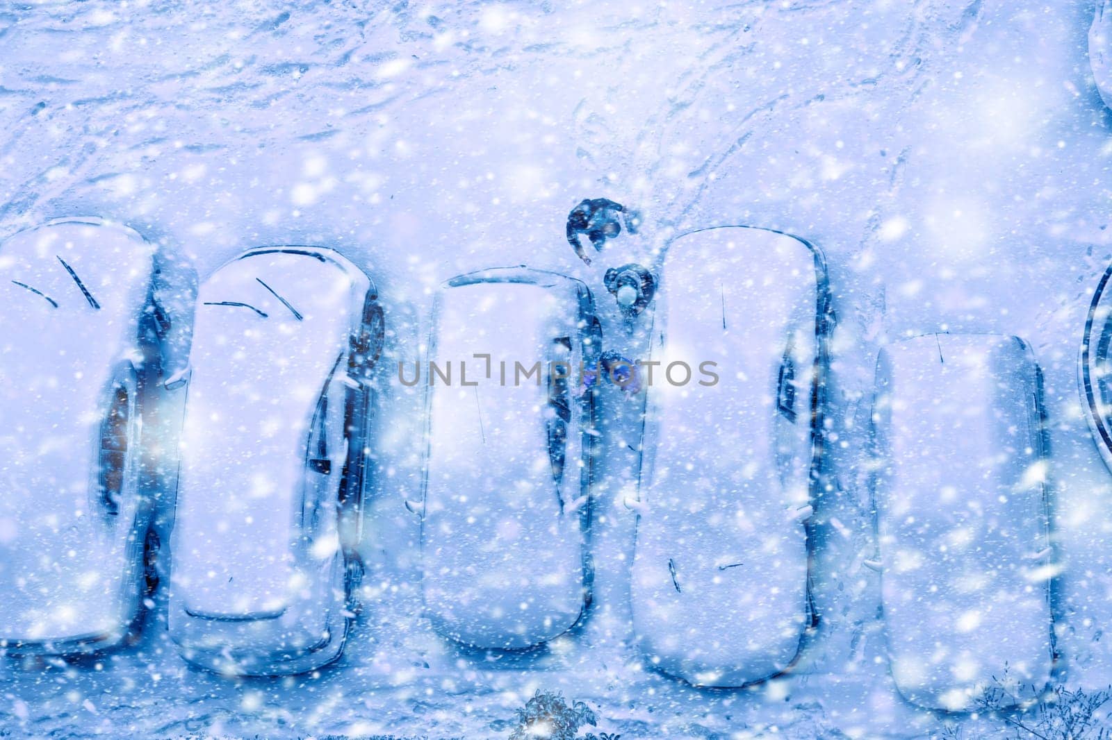 Elevated view of children play in snow covered parking lot