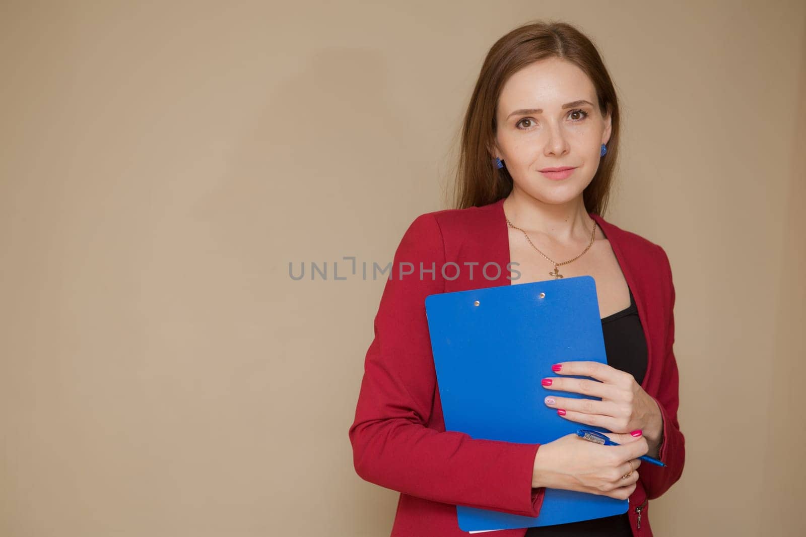 Happy beautiful business woman with clipboard in the office.