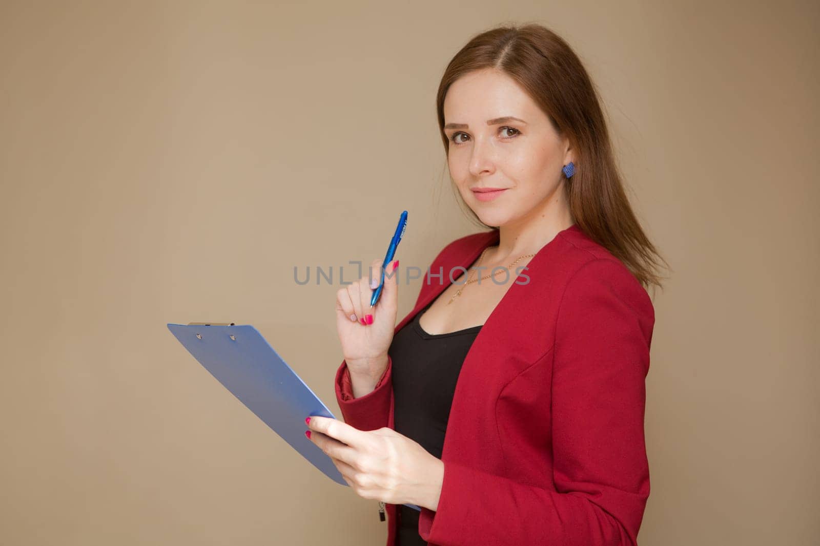 Happy beautiful business woman with clipboard in the office.