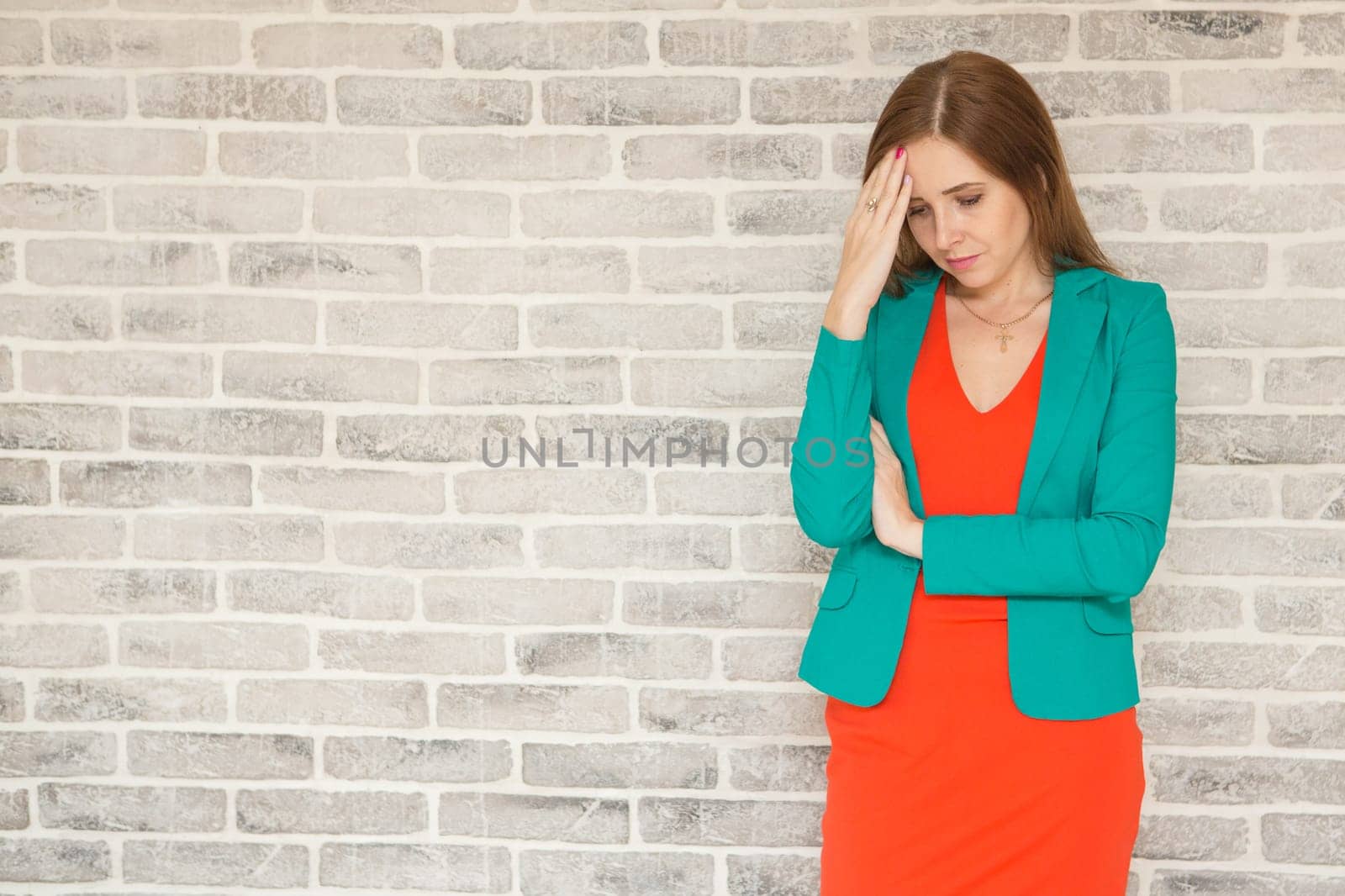 Young woman with headache, holding head, sad, sad brooding