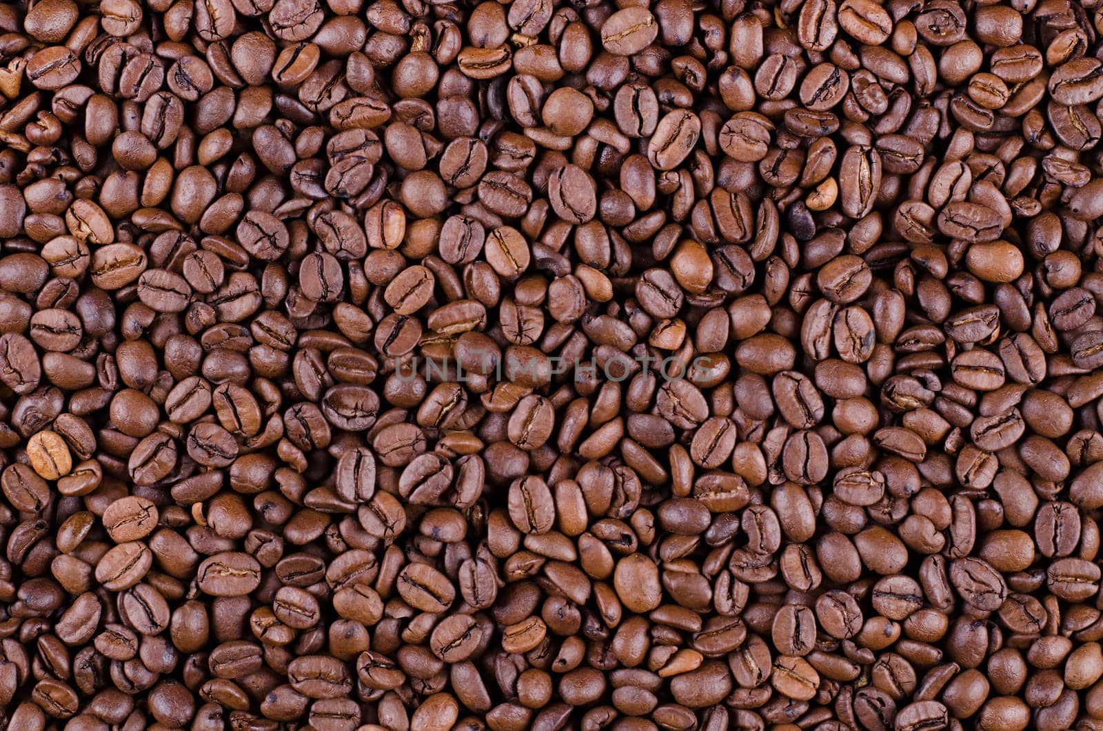 Background of coffee beans. Dropped brown coffee beans.