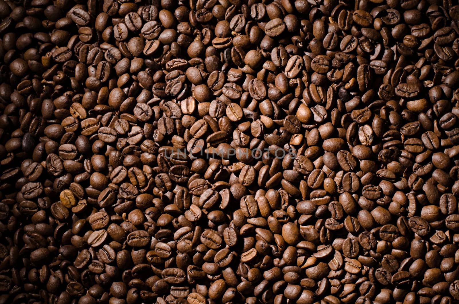 Background of coffee beans. Dropped brown coffee beans.