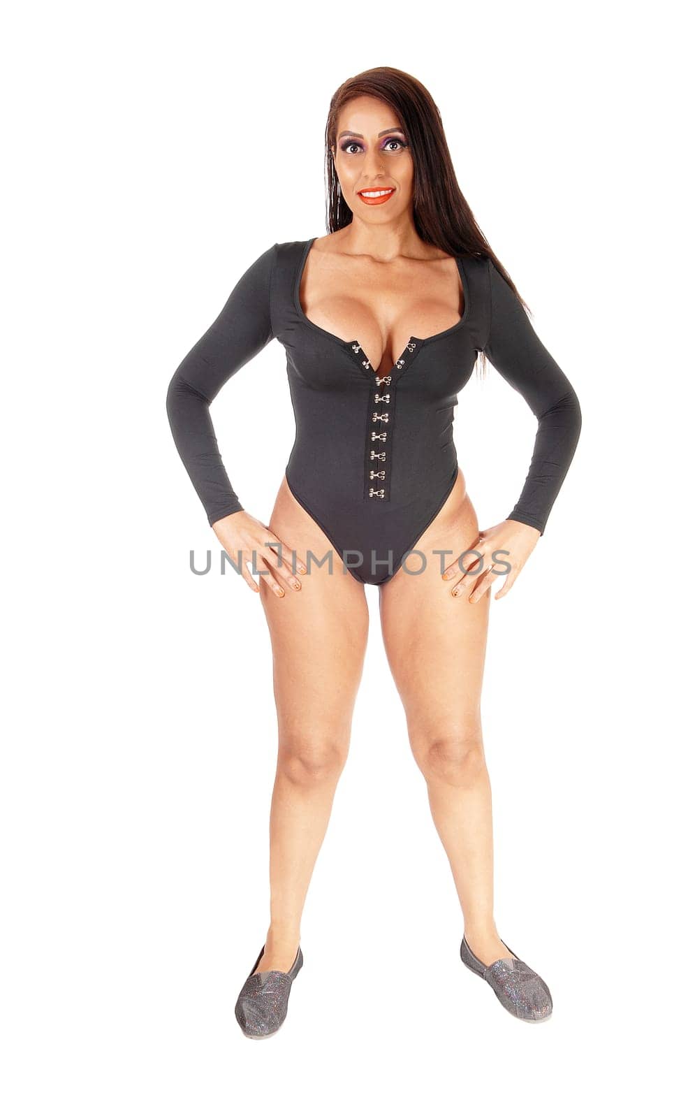 A young gorgeous woman standing in full length in a black body suit.from the front, with her long black hair, isolated for white background.