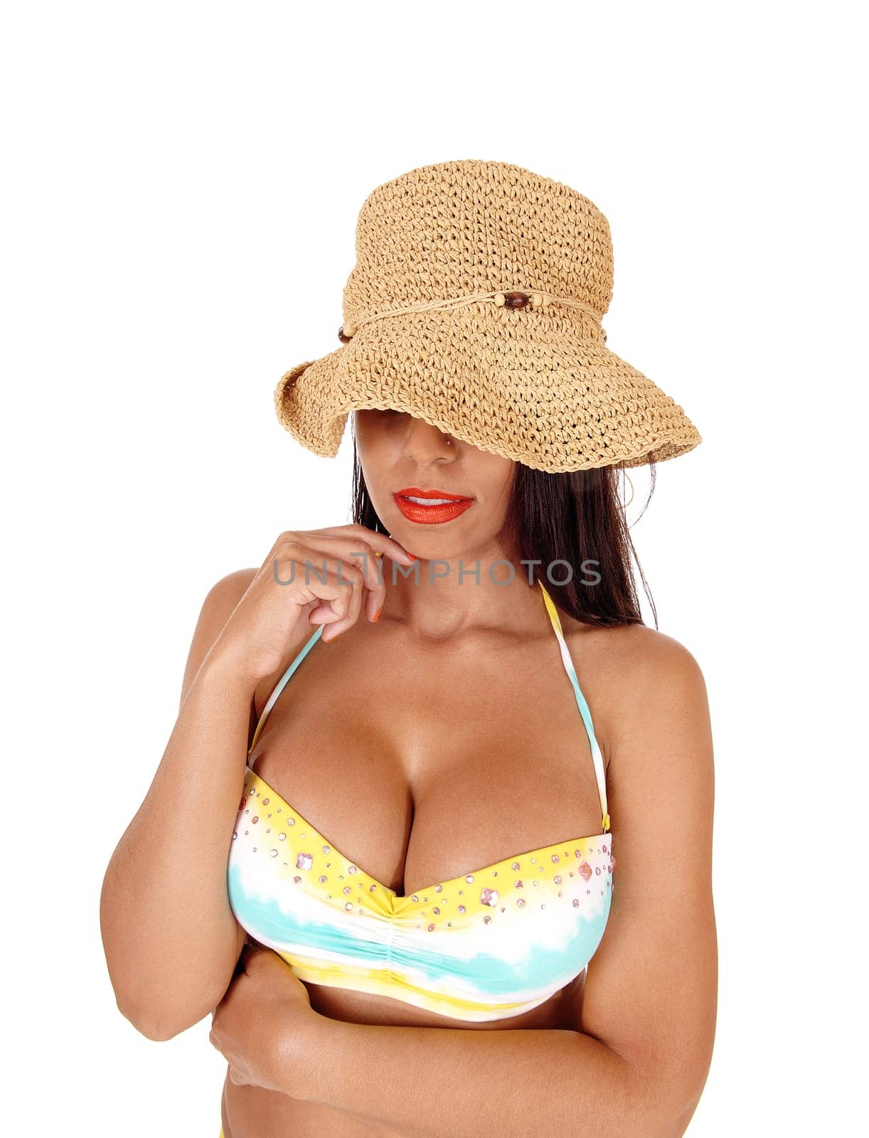 A beautiful young woman wearing a big straw hat over her eyes with.red lips and bikini top, isolated for white background.