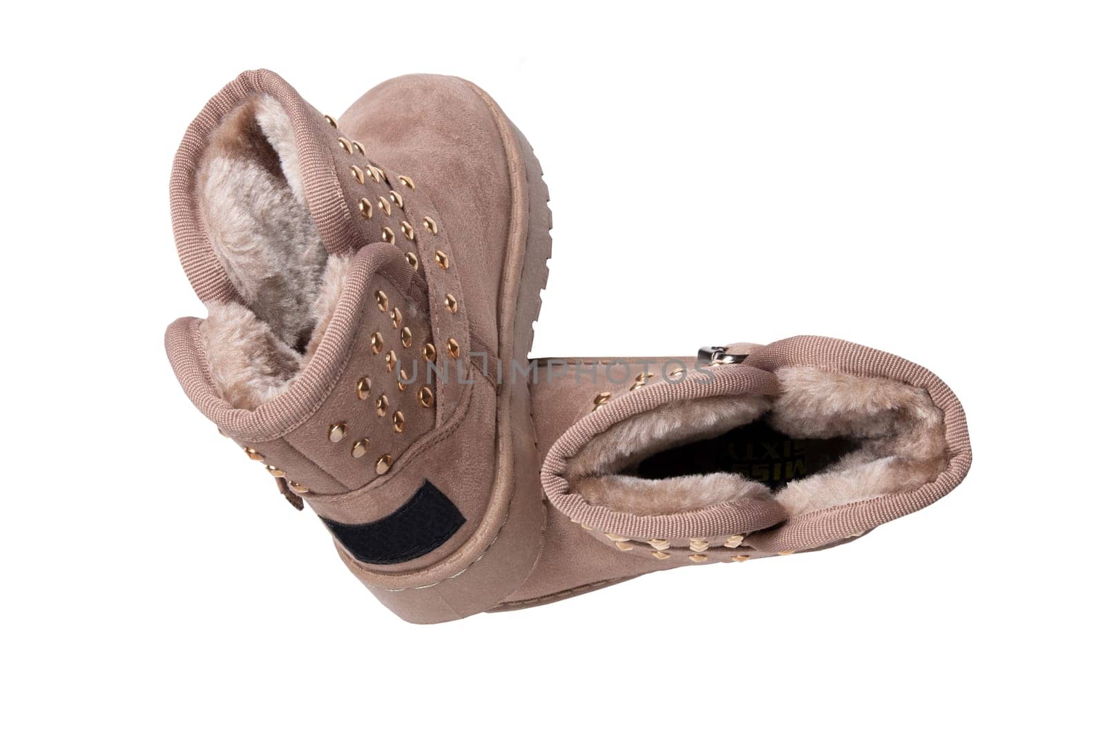 Winter boots. A pair brown suede leather winter boots and lined with fur.  Isolated on a white background. Shoe fashion new collection winter 2018 to 2019.