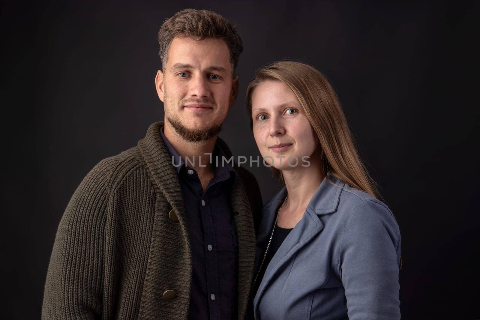 Portrait in the studio of two young business partners standing face to face