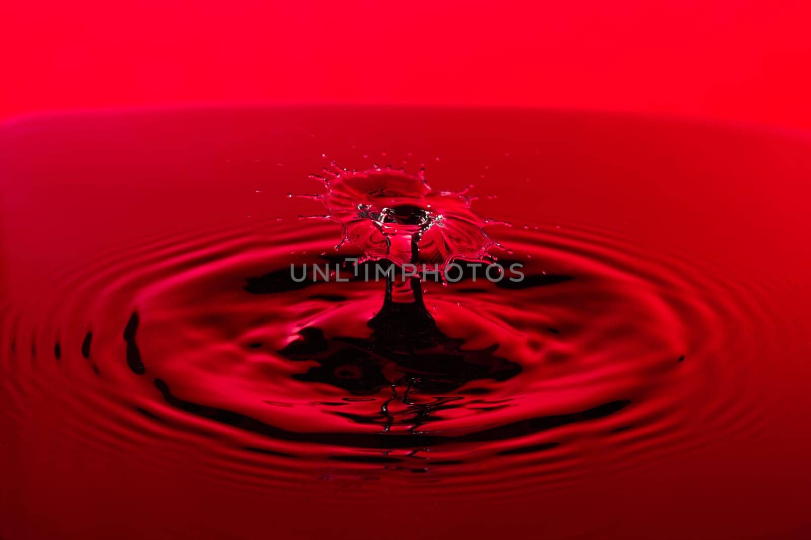 Red Water Droplet Splash Close Up.