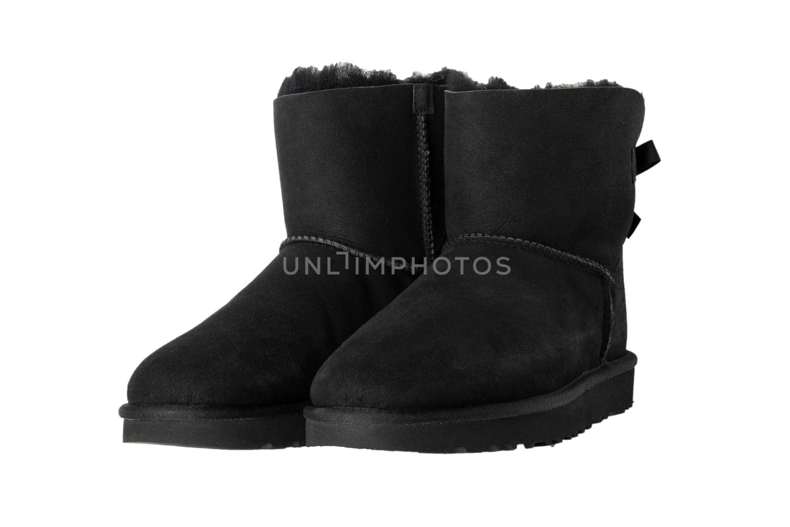 Winter boots. A pair black suede leather winter boots and lined with fur.  Isolated on a white background. Shoe fashion new collection winter 2018 to 2019.