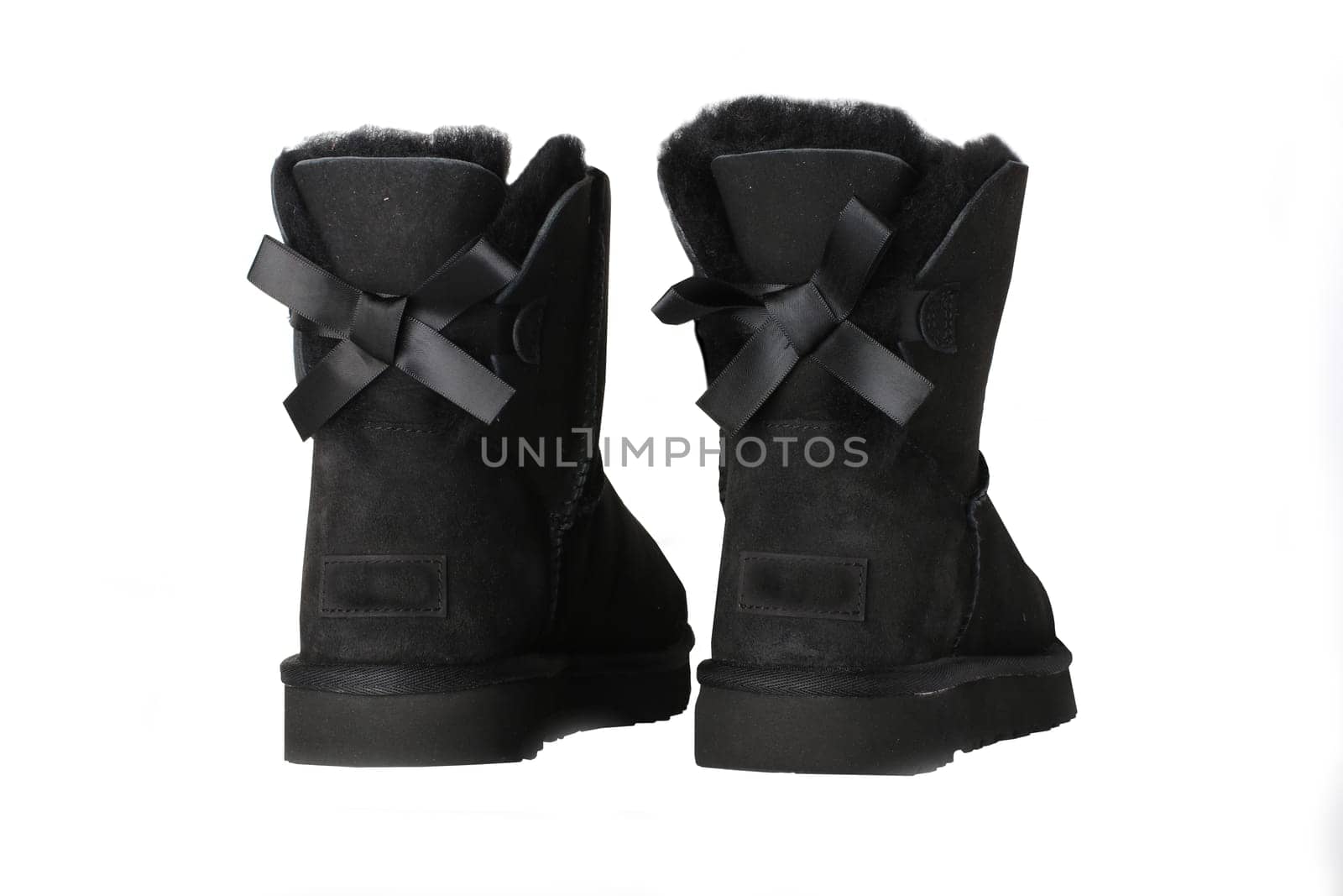 Winter boots. A pair black suede leather winter boots and lined with fur.  Isolated on a white background. Shoe fashion new collection winter 2018 to 2019.