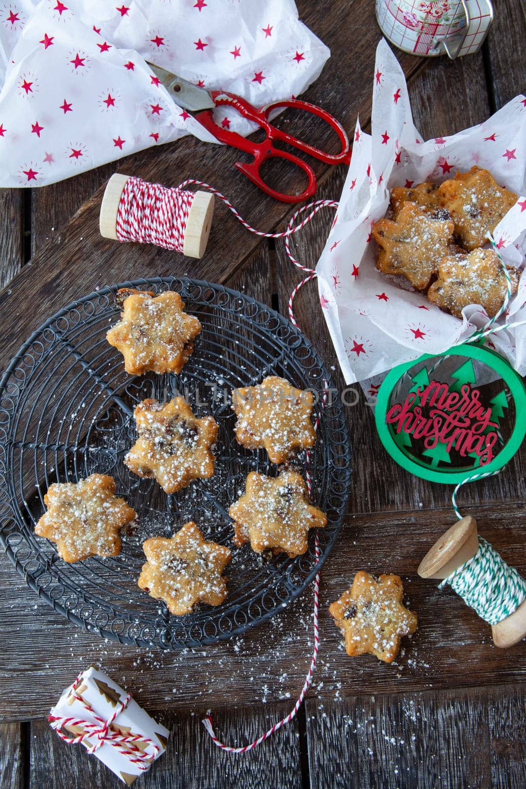 Traditional Christmas cookies with raisins on a rustic wooden background