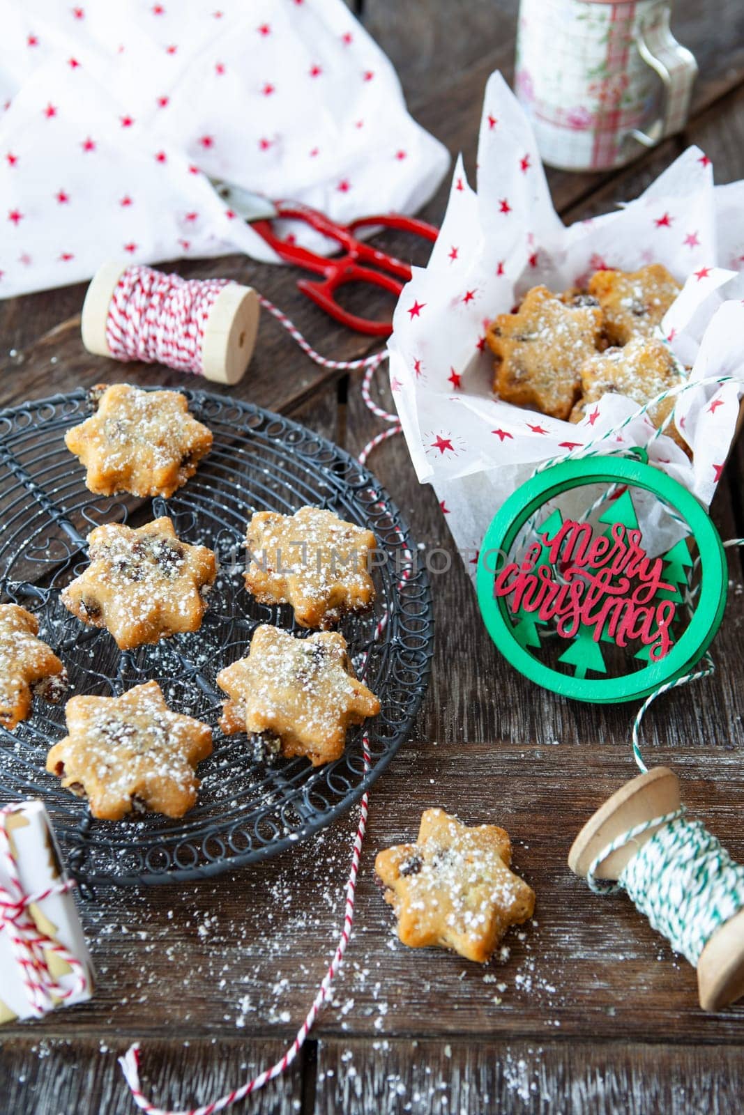Traditional Christmas cookies with raisins on a rustic wooden background