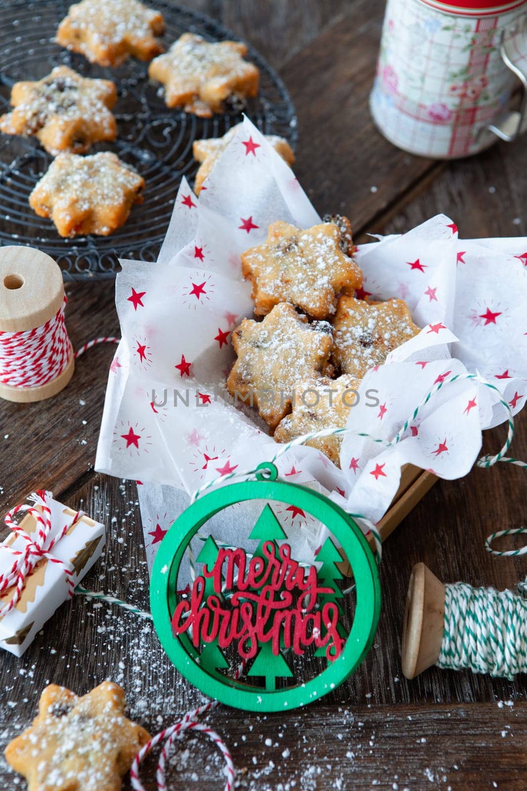 Traditional Christmas cookies with raisins on a rustic wooden background