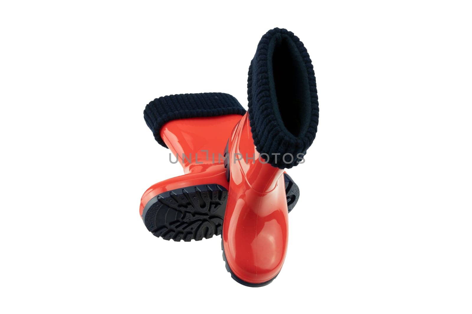 Children shoes and boots. Closeup of a pair red rubber boots isolated on a white background. Kids shoes fashion.