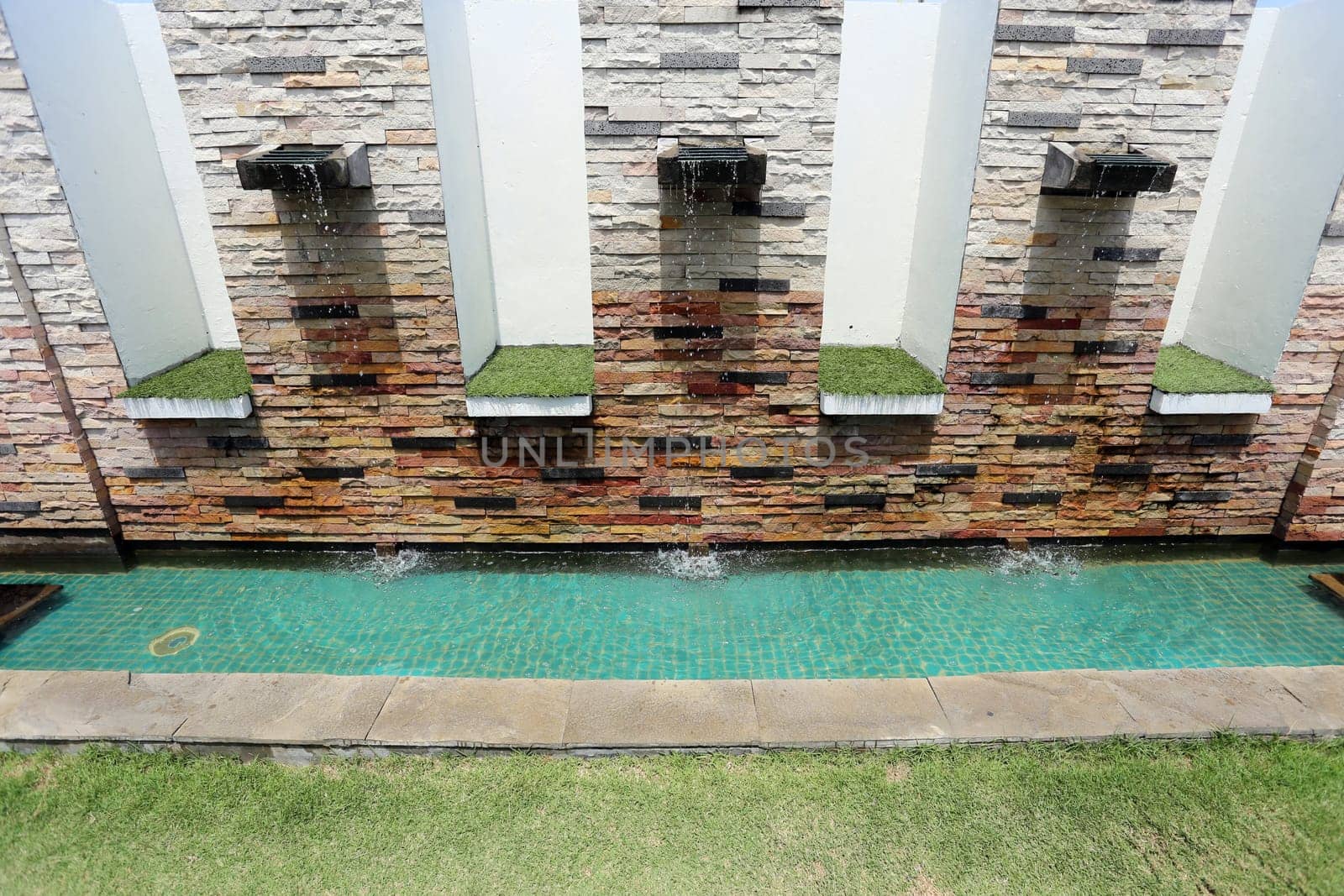 Beautiful wall is covered with multi-colored tiles