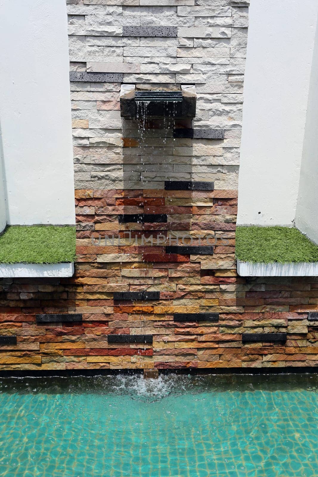 Beautiful wall is covered with multi-colored tiles