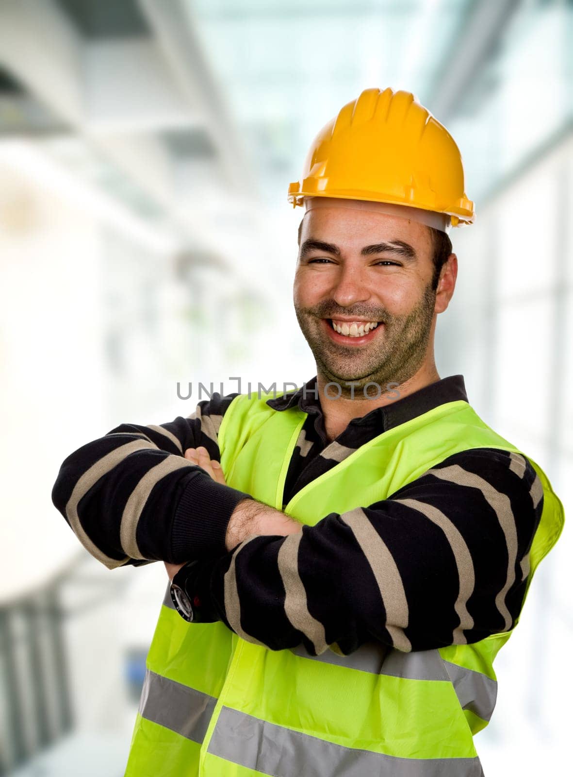 happy young worker inside a modern building
