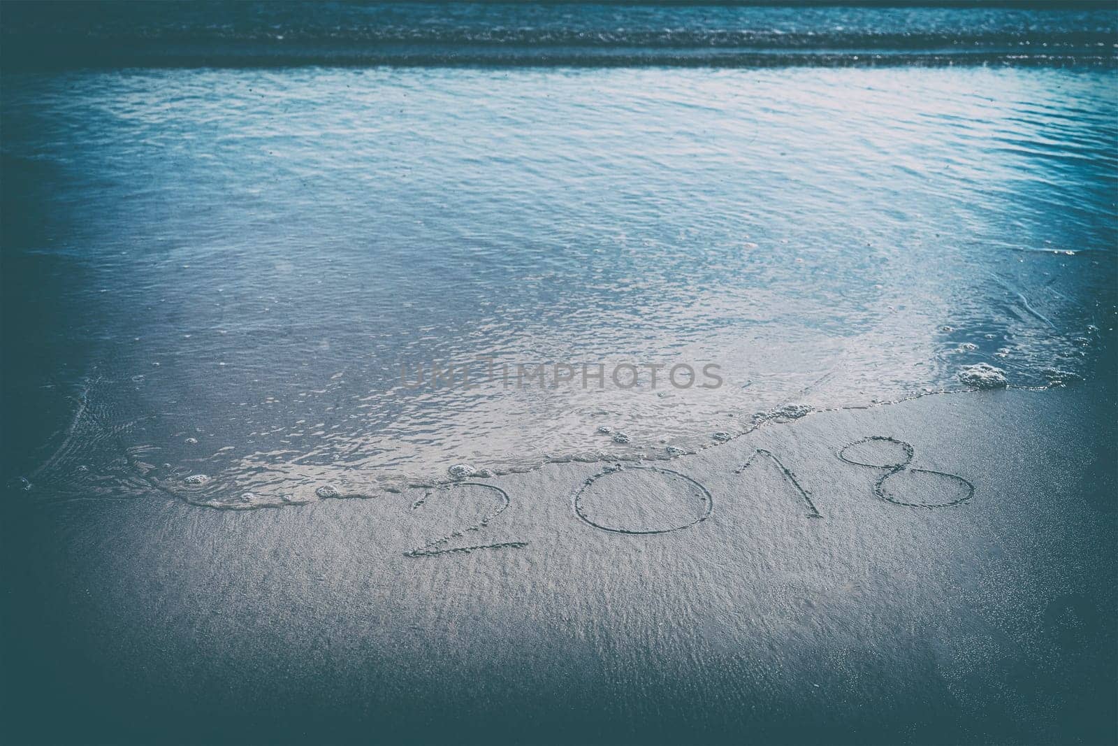Old Year 2018 expires on ocean beach lettering