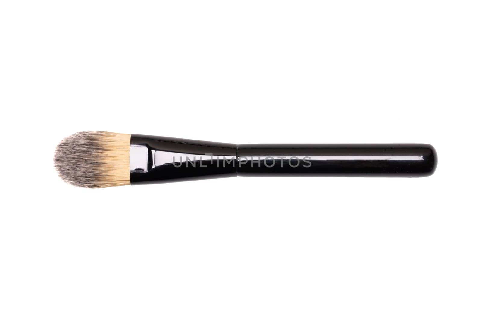Beauty products. Closeup of a new make-up brush isolated an a white background. Makeup cosmetic tools. Macro.