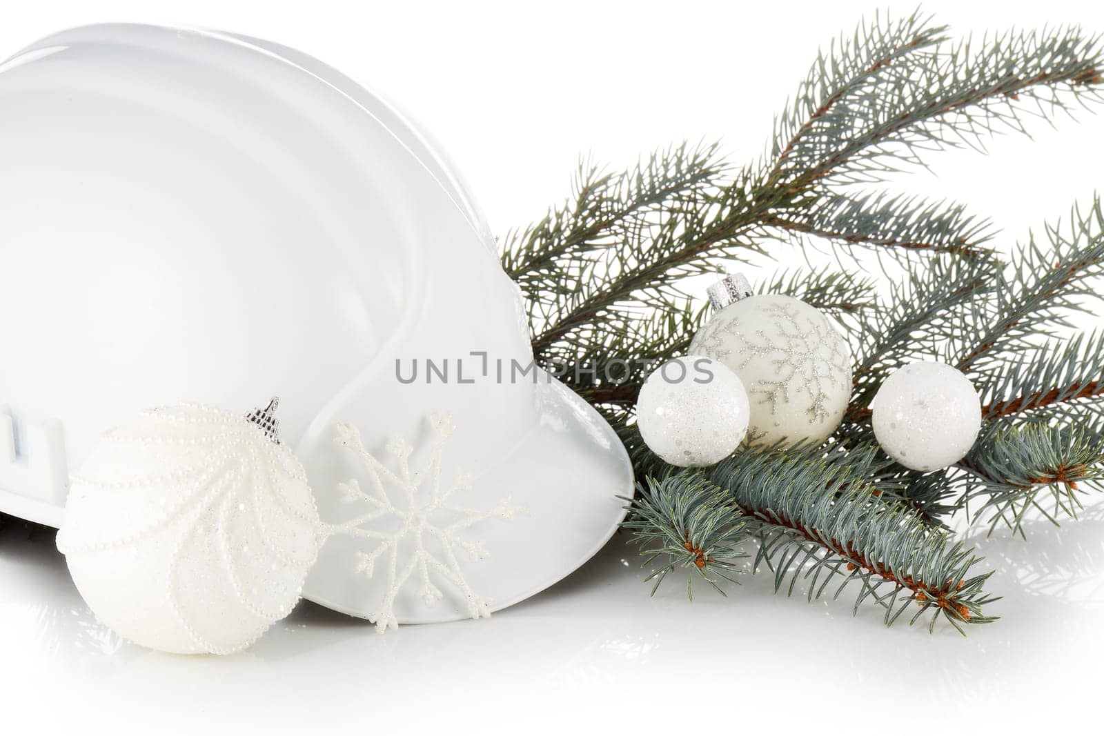 Construction hard hat, fir tree branches and Christmas ornament isolated on a white background. New Year and Christmas. Horizontal view.