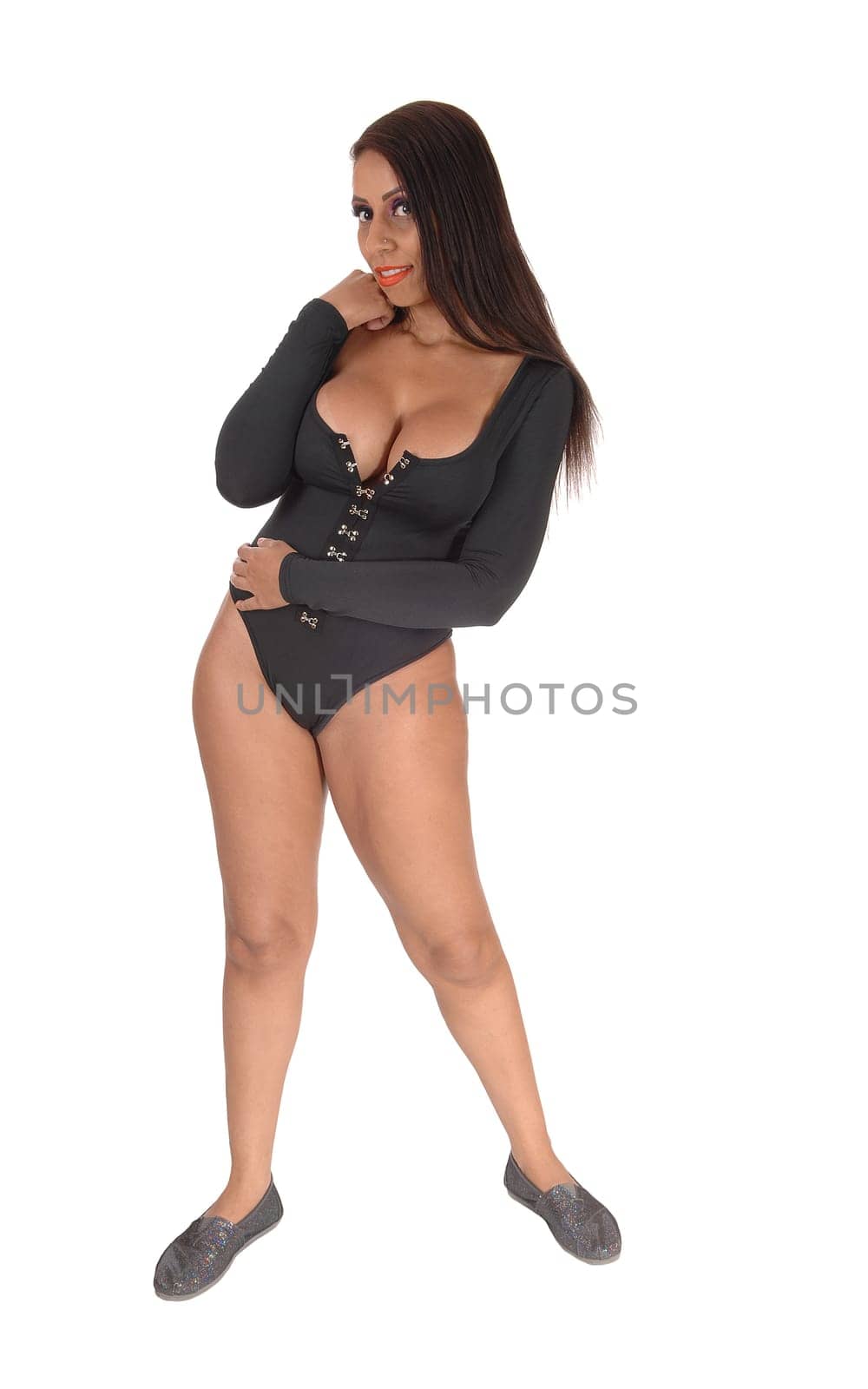 A young gorgeous woman standing in full length in a black bodysuit.from the front with her long hair, isolated for white background.