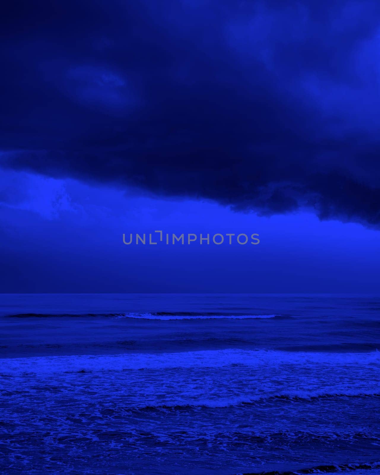 seascape image of waves on sea over stormy sky