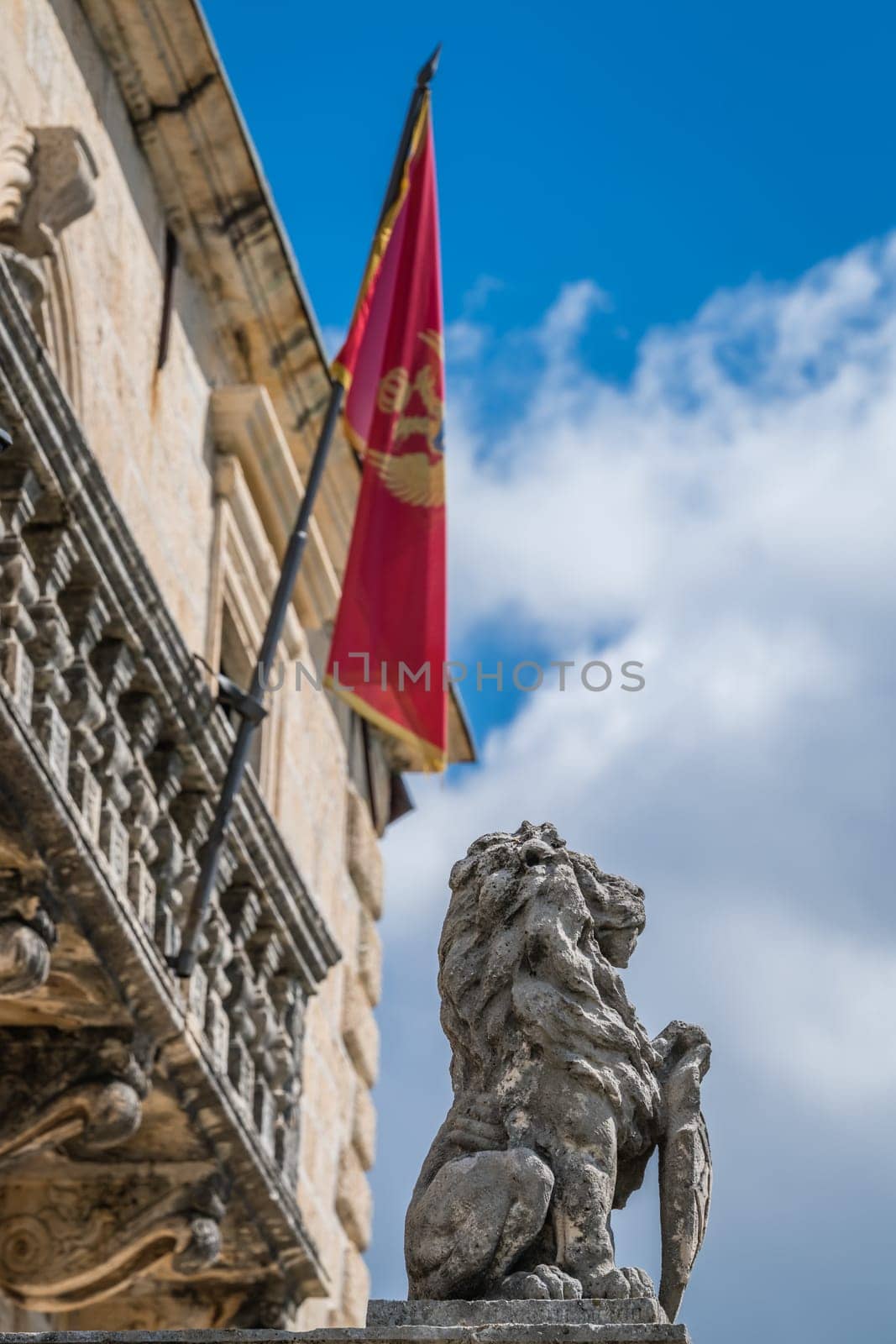 Ancient lion statue in front of a municipal building in Perast town, Kotor Bay, Montenegro