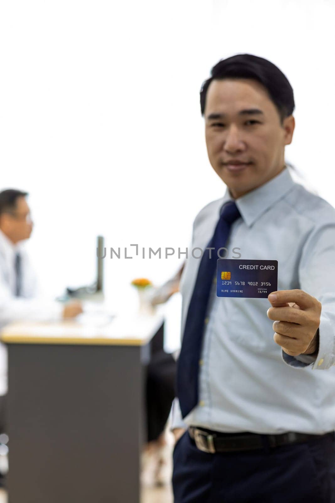 Portrait of Young adult Patient with credit card with examination room medical office background for insurance concept