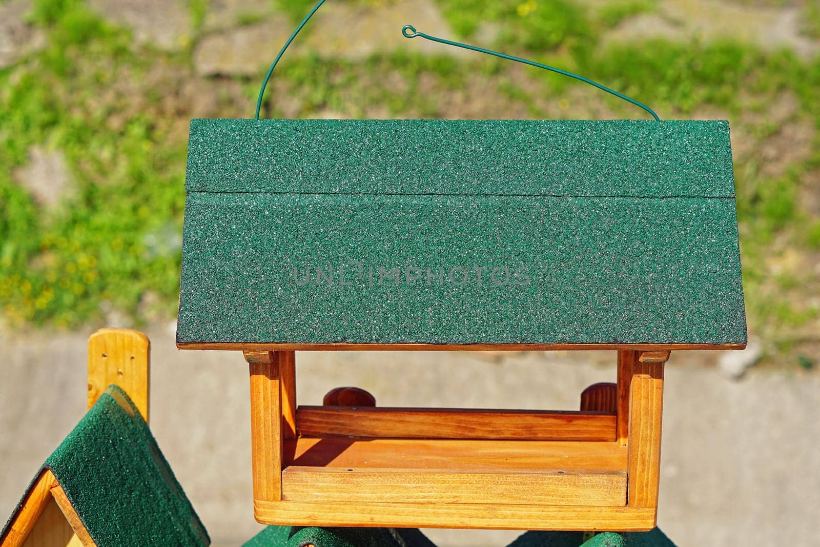 New wooden bird feed house with green roof