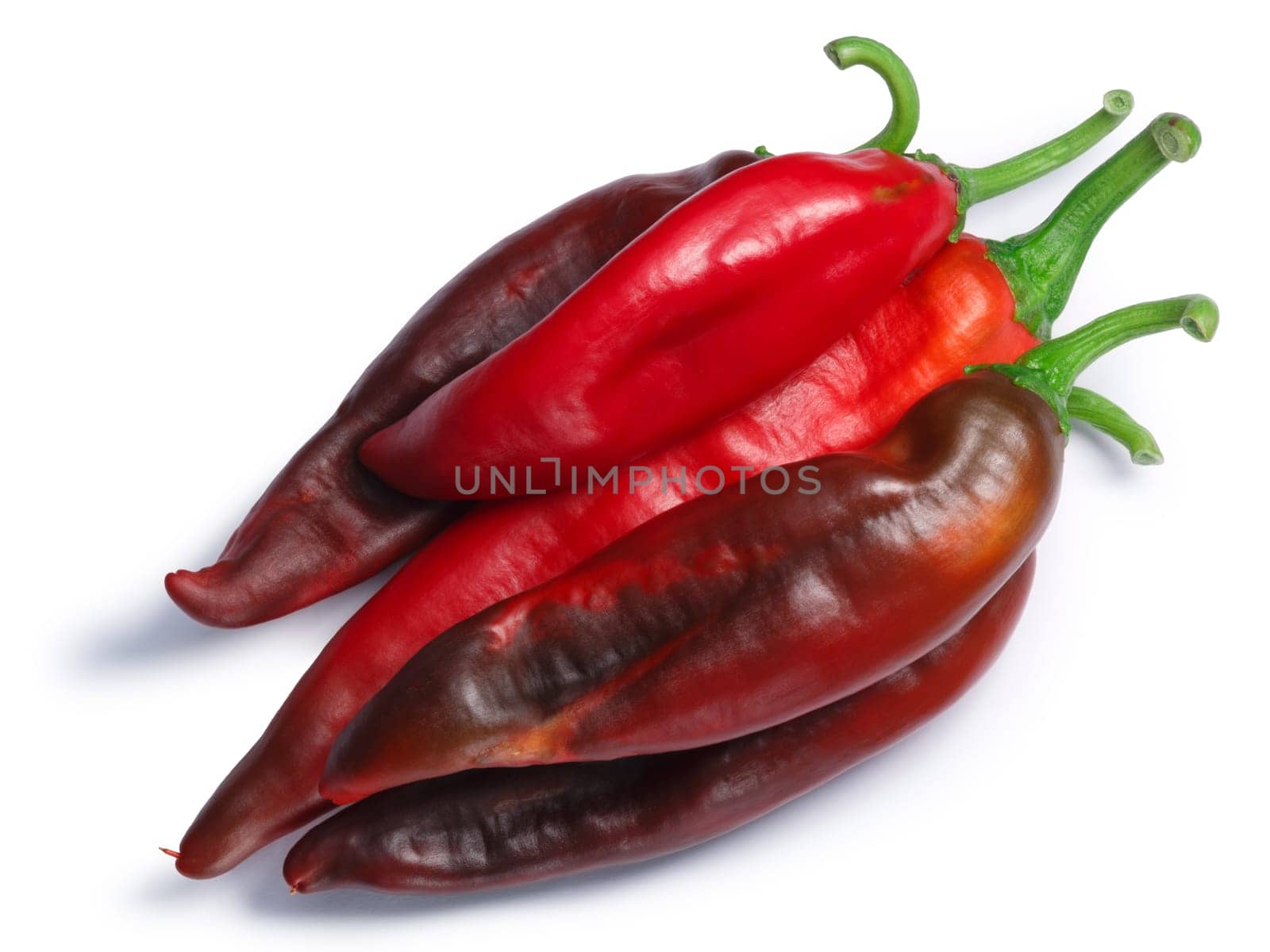 Ripe Hatch red chiles (Numex New Mexico pod type, Capsicum annuum), pile of, top view. Clipping paths, shadows separated