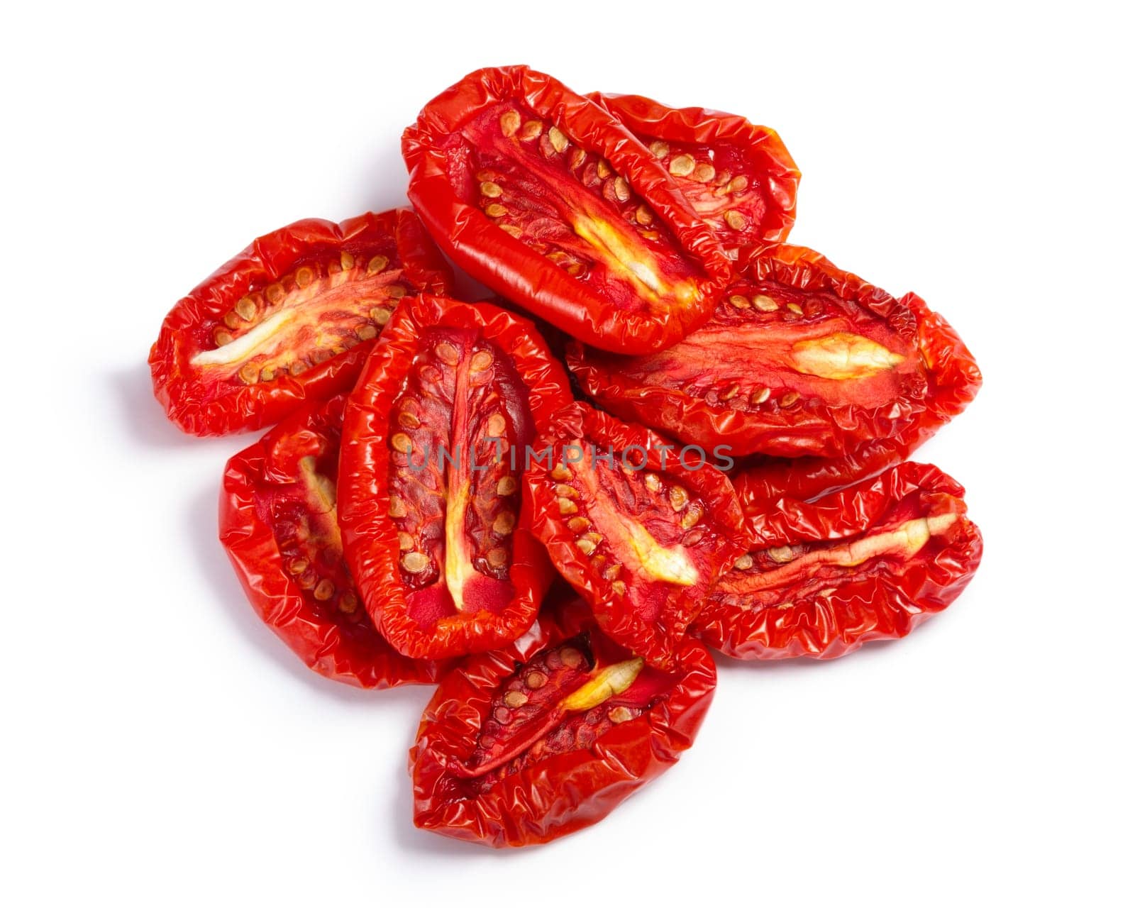 Pile of sundried or dried tomato halves, top view. Clipping paths, shadow separated