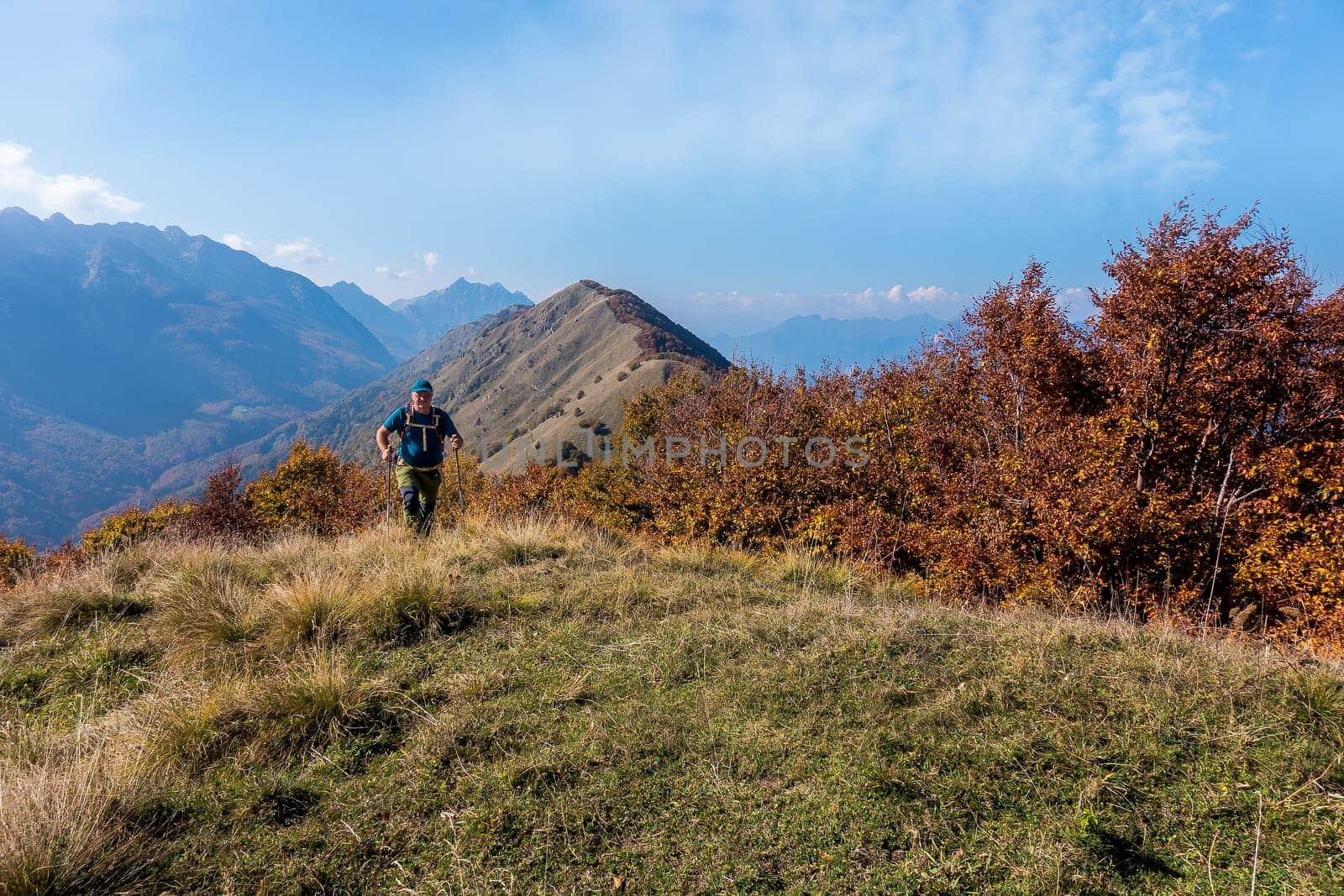Man hiker walking on the top of mountain