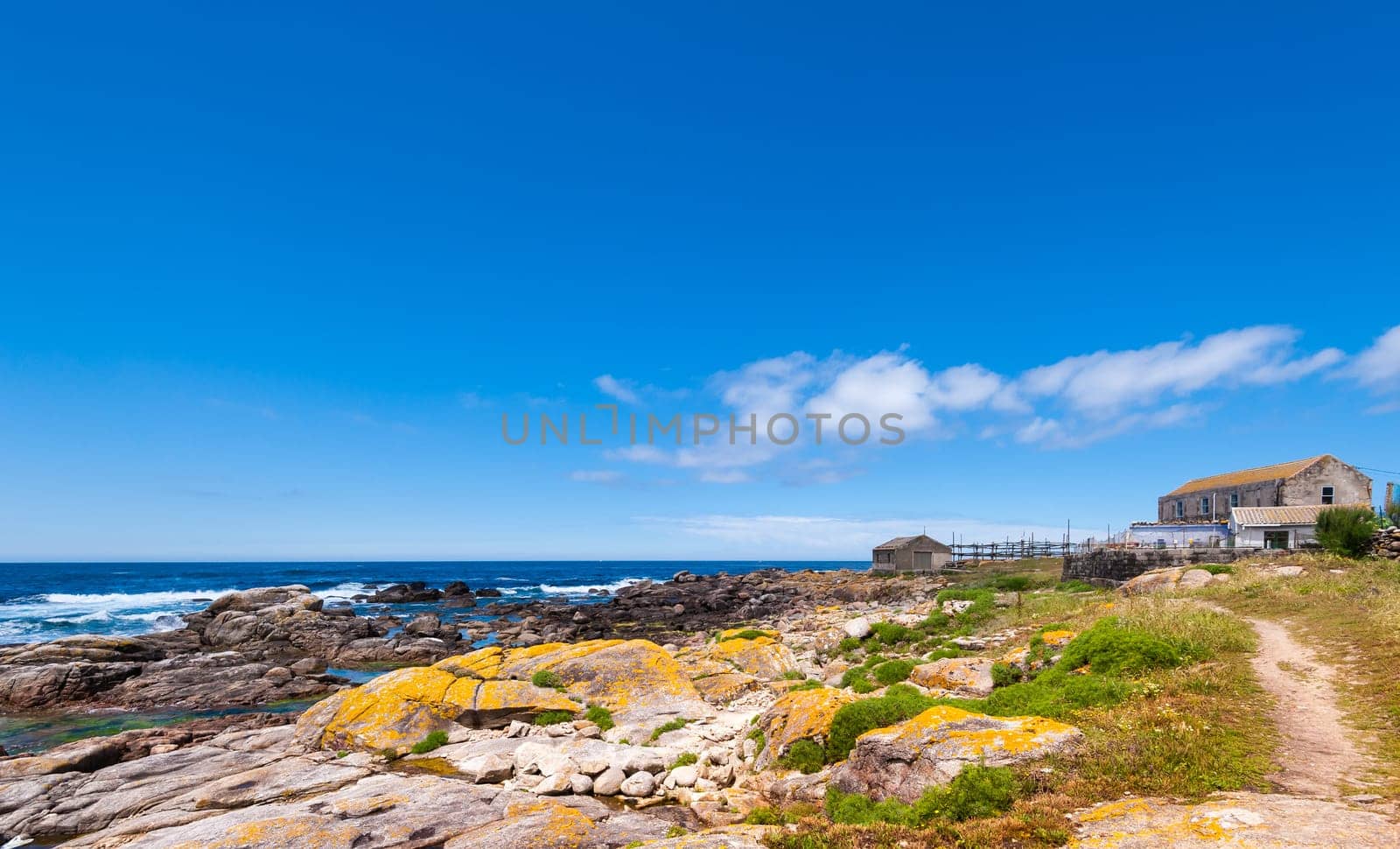 Landscape with sea,cliff, beach and blue sky. Galicia Spain. Vacation travel.