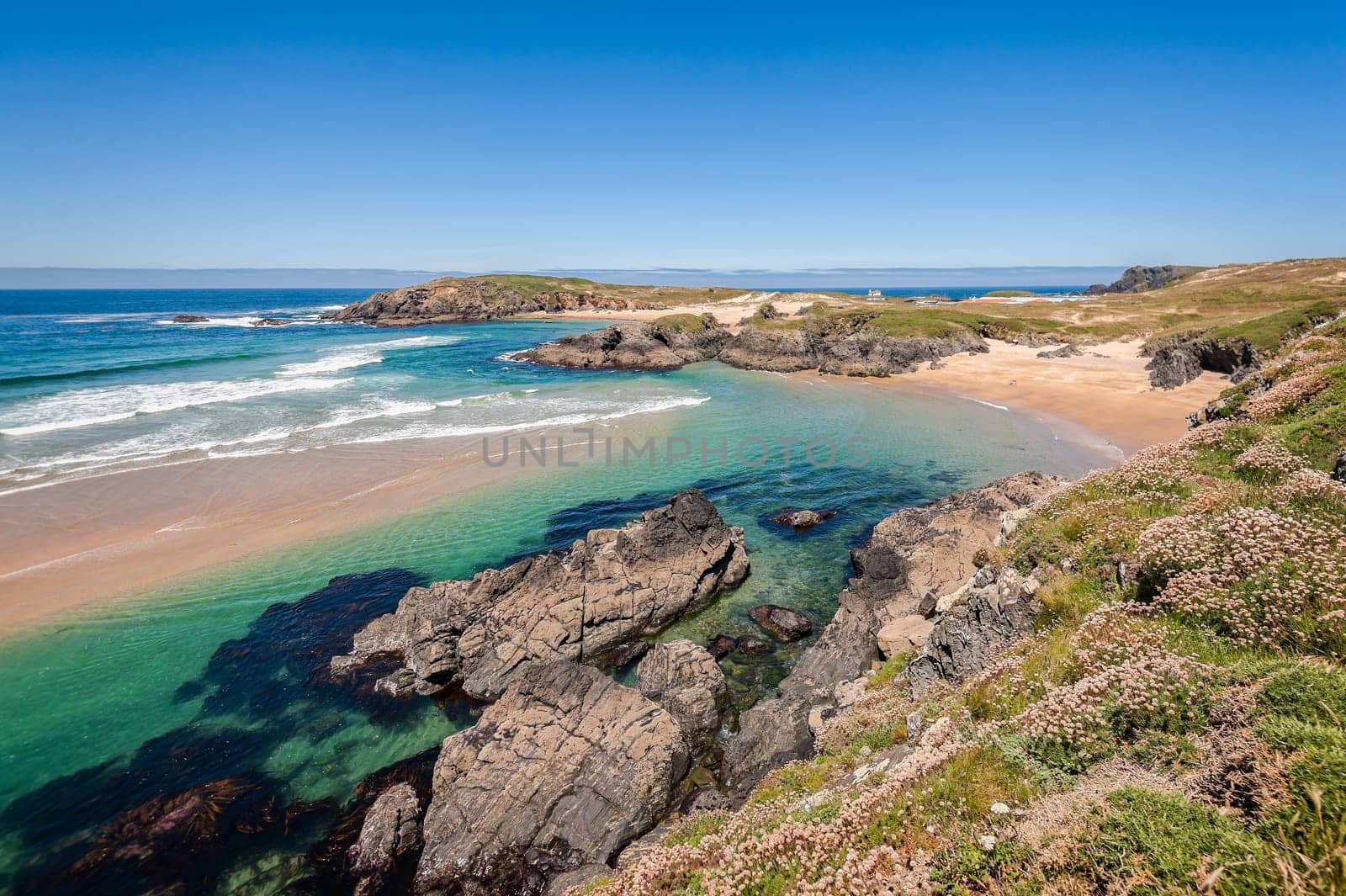 Landscape with sea,cliff, beach and blue sky. Galicia Spain. Vacation travel.