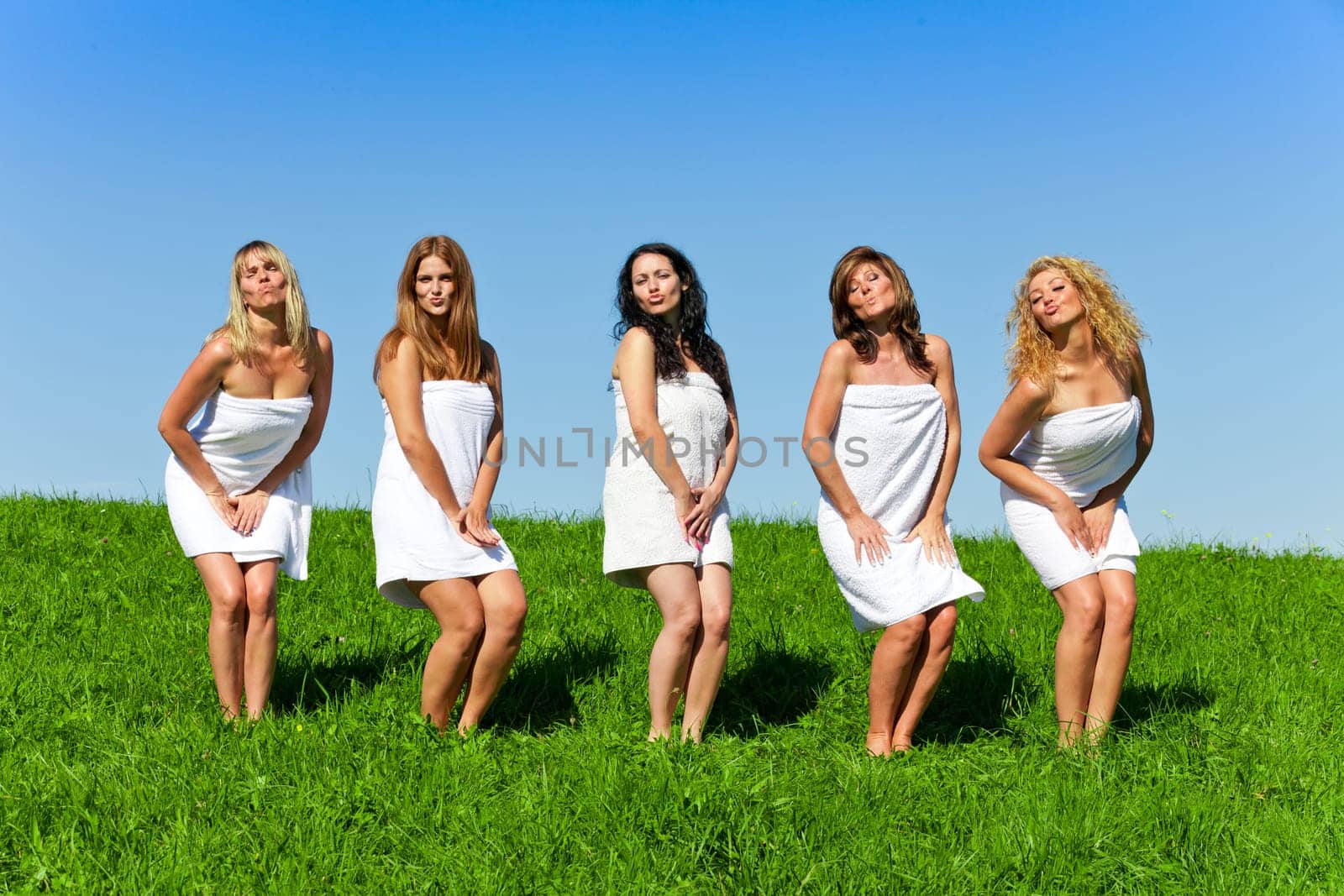 Woman group in towel on the summer meadow