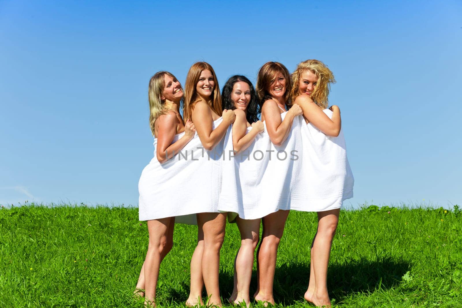 Woman group in towel on the summer meadow