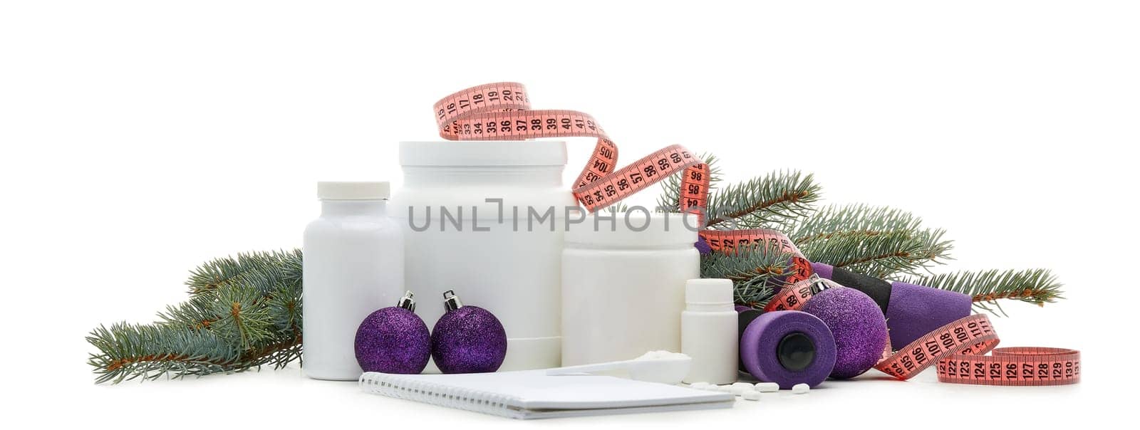 Sports nutrition (supplements), dumbbells, fir tree branches and christmas ormament on a white background. Horizontal view. New Year and Christmas. Fitness. Healthy lifestyle.