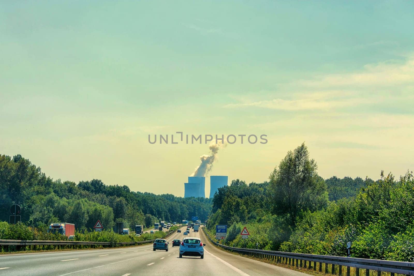 UNNA, GERMANY - AUGUST 2, 2017: Traffic on the A2 motorway and Scholven coal power station, Germany, North Rhine-Westphalia.