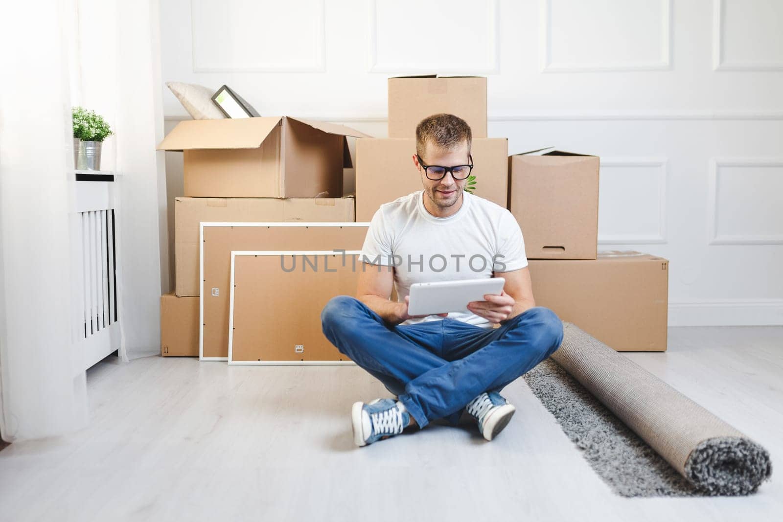 Handsome young man moving into his new home