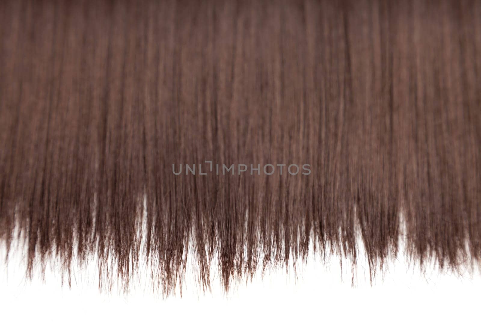 Closeup on luxurious straight glossy brown hair