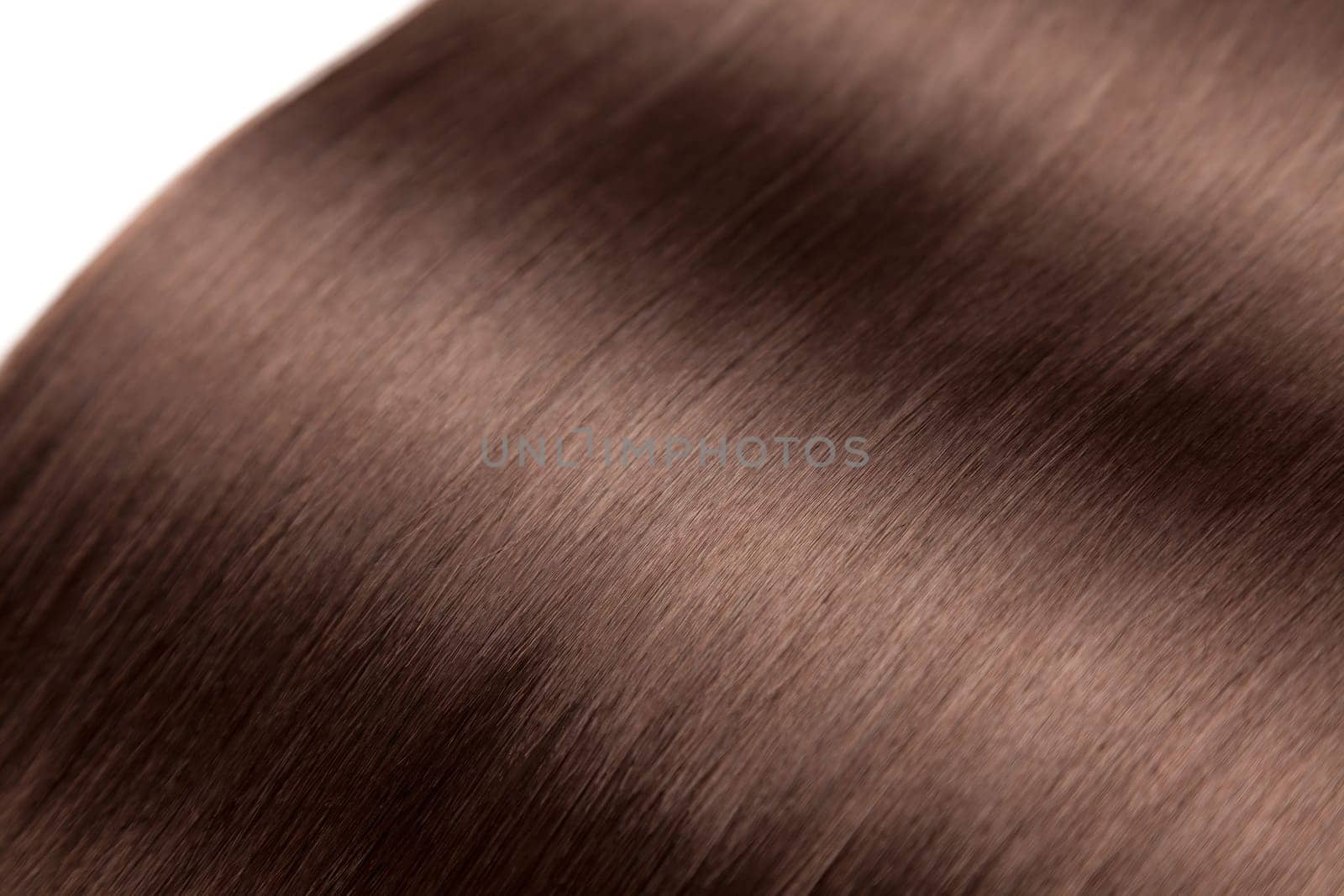 Closeup on luxurious straight glossy brown hair